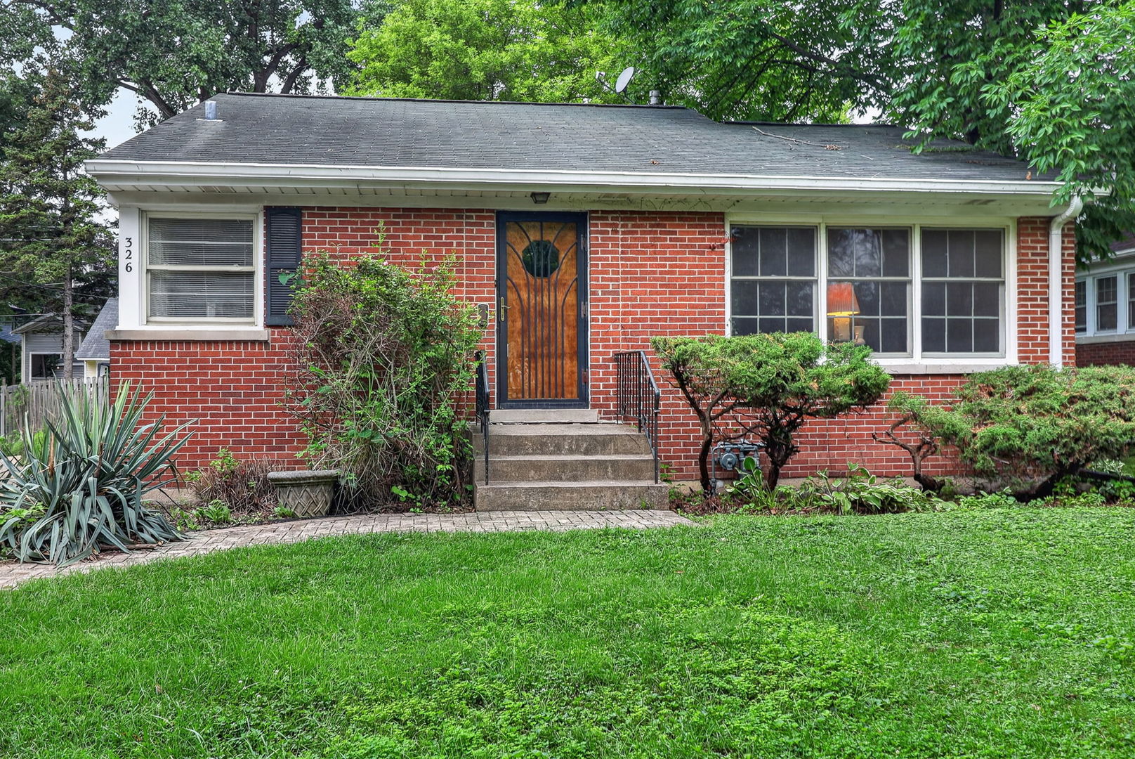 This mid-century modern ranch keeps its original character and sits in the heart of La Grange Park. Located in a charming neighborhood, close to shopping, schools, the train, and other local amenities. The home has two bedrooms and one bathroom, plus a relaxing screen porch off the living room. Hardwood floors throughout, clean and freshly painted! The full unfinished basement offers plenty of space for storage and future living areas. Outside, you'll find a big yard, a custom brick driveway, and a two-car garage. Solidly built home with steel beams and all-brick construction.