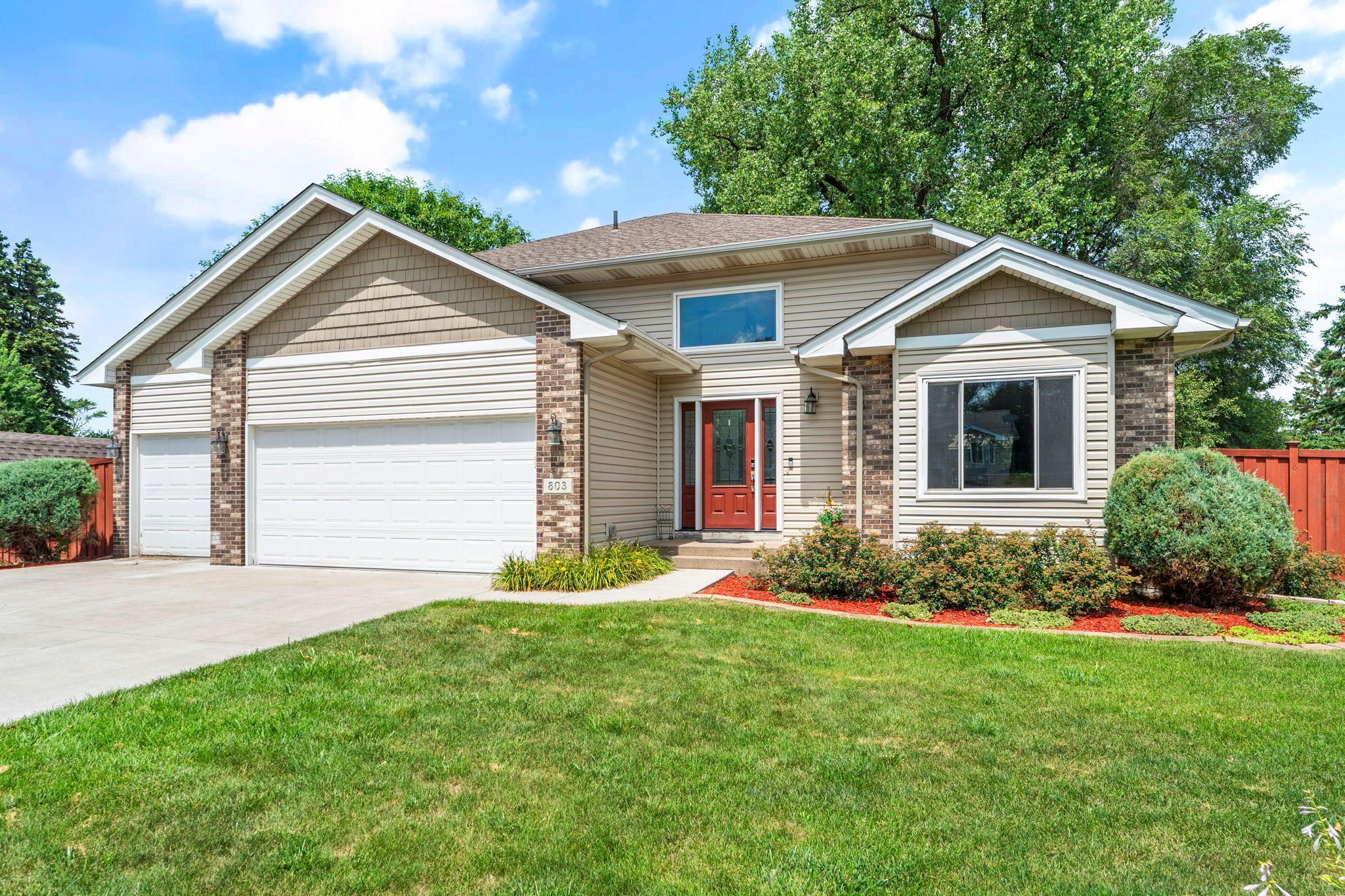 Welcome to this charming five-bedroom, two-bathroom home nestled in a quiet Blaine neighborhood. As you enter, you’re greeted by a bright and inviting atmosphere with soaring vaulted ceilings and an open, spacious feel throughout the main level. The kitchen features stainless steel appliances, quartz countertops, a stylish tile backsplash, breakfast bar seating, and ample wood cabinetry. A large front-facing window fills the space with natural light, while the kitchen flows seamlessly into the dining area with sliding door access to the spacious deck and fully fenced backyard—perfect for everyday living and entertaining. Just a few steps up, the living room offers hardwood flooring, a ceiling fan, large windows, and an open railing overlooking the kitchen and dining area. The upper level features three bedrooms, including a primary suite with generous closet space. Bedrooms two and three are similar in size, with one offering hardwood flooring and the other carpeting, both with ample closet space. They share a spacious full bathroom with a double vanity, jetted soaking tub, and walk-in shower. The finished lower level provides two additional bedrooms, each with lookout windows and ample closet space. They share a full bathroom with tile flooring, a single vanity, and a tub/shower combination. Outside, enjoy a spacious fully fenced backyard with an in-ground sprinkler system, ideal for pets, gardening, or outdoor activities. The attached three-car garage provides plenty of space for vehicles, storage, and hobbies. Additional updates include a sealed driveway (2020), new lower-level bathroom (2024), new deck railing (2025), new furnace and air conditioner (2025), new windows (2019), and a new roof (2019). Don’t miss the opportunity to own this beautifully updated home in a desirable Blaine neighborhood.
