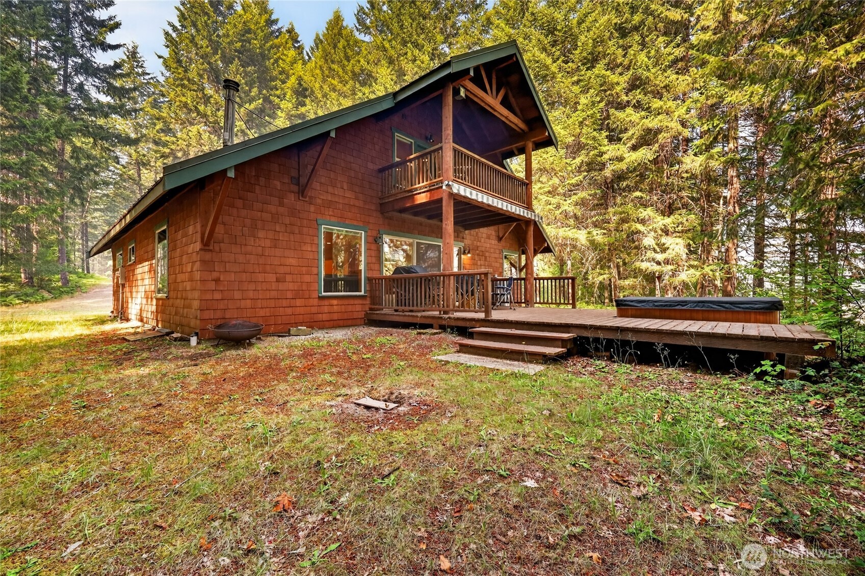 Nestled on just over 7 acres, this beautiful 4-bedroom, 4-bath home offers the perfect combination of privacy, comfort, and Pacific Northwest charm. Enjoy a peek-a-boo view of the Cowlitz River while surrounded by mature trees and the serenity of nature.Designed with both everyday living and entertaining in mind, the home features beautiful solid wood flooring throughout the main living areas and carpeting in each bedroom. The spacious kitchen has granite countertops, custom cabinetry, and a convenient prep sink, providing abundant workspace for cooking and gathering.The inviting living room is centered around a cozy wood-burning stove, creating a warm and welcoming atmosphere year-round. Step outside onto the back deck and unwind in the hot tub while enjoying the peaceful woodland setting and peek-a-boo river view.The property also includes a two-car carport with an attached single-car garage, offering plenty of covered parking and storage for vehicles, outdoor gear, and recreational equipment.Whether you're looking for a full-time residence, a mountain getaway, or a vacation rental opportunity, this exceptional property offers privacy, space, and easy access to all that Packwood has to offer.  Located in the Cowlitz Vista gated community, this property combines privacy with quality craftsmanship, comfortable living and the natural beauty of the Pacific Northwest.