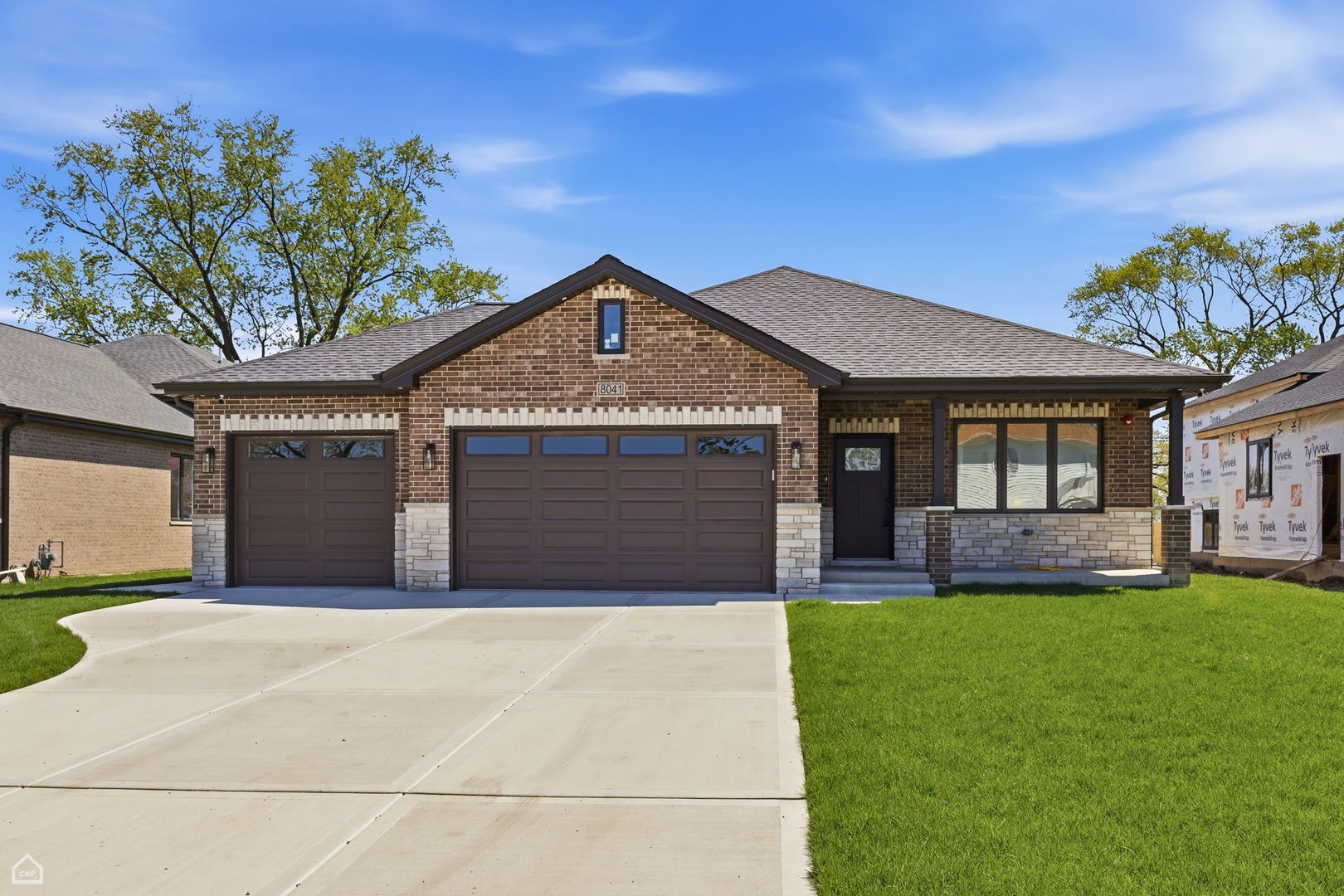 Step into exceptional craftsmanship in this brand-new, custom-built 5-bedroom, 3-bathroom split-level designed for modern living and effortless entertaining.  The open-concept main level makes a striking first impression with soaring 20-foot vaulted ceilings, skylight, and site-finished oak hardwood floors. At the heart of the home, the kitchen features an oversized island and direct, seamless access to the backyard - perfect for indoor-outdoor hosting. A highly flexible main-floor bedroom serves ideally as a guest room or private home office. Upstairs, you'll find 3 spacious bedrooms, including a private primary suite with its own dedicated bath, alongside a full hallway bathroom servicing the additional bedrooms. The lower level offers a family room anchored by a dramatic floor-to-ceiling fireplace with custom built-ins, alongside a private lower-level guest suite. Downstairs, the full sub-basement features high 8-foot ceilings, offering massive potential for customization, and comes equipped with an interior drain tile system.  Complete with an attached 3-car garage and a hardwired security camera system. Turnkey luxury, prime spatial design, and brand-new construction - ready for its first owner.