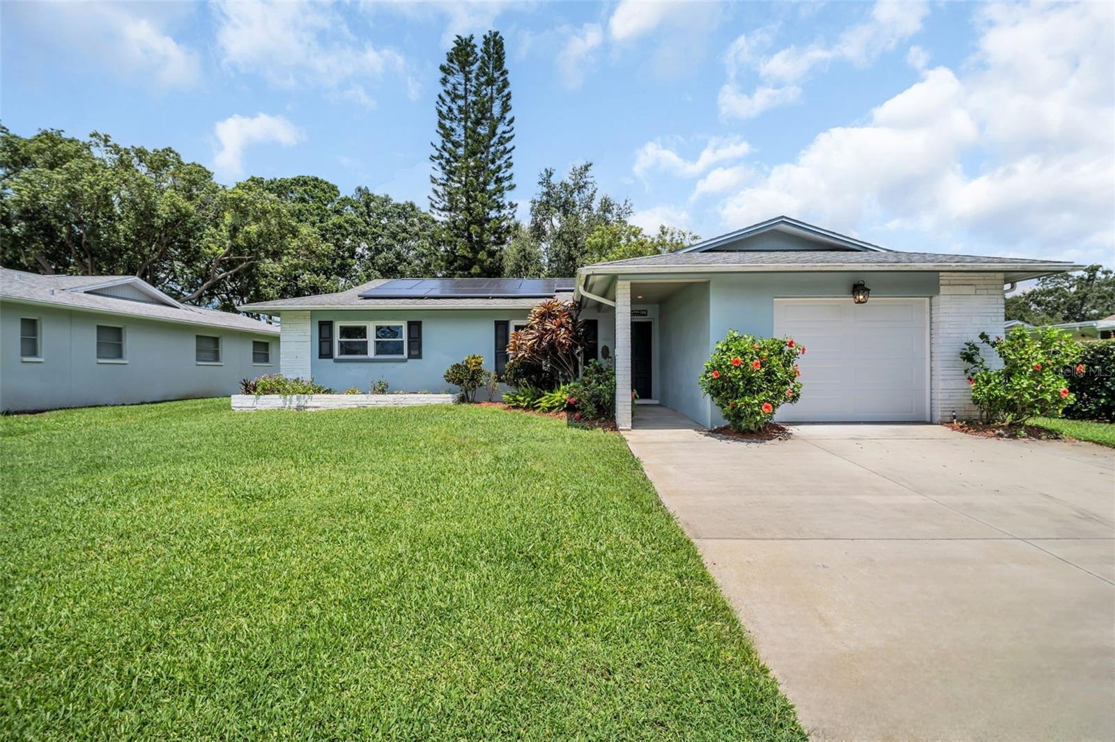 Welcome to this beautifully updated 2-bedroom, 1.5-bath home nestled in Palm Harbor’s premier 55+ golf and lakefront community—Highland Lakes. From the moment you step inside, you’ll appreciate the inviting front entry, newer luxury vinyl plank flooring throughout the main living areas, and a freshly painted interior that is bright and airy with abundant natural light. Both spacious bedrooms feature brand new carpet, and the bathrooms have been thoughtfully renovated with stylish new vanities, updated lighting, and a gorgeous walk-in shower. The dining area flows seamlessly into the kitchen, which boasts sleek stainless steel appliances, a new deep sink, eat-in space for casual meals, and a convenient pass-through window to the lanai—perfect for entertaining. Major updates include a new HVAC system (2024), updated electrical panel (2020), hot water heater (2022), and updated windows, all contributing to peace of mind and low-maintenance living. Situated safely above the flood plain, this home recently passed a 4-point inspection with flying colors, offering worry-free insurance eligibility. Highland Lakes residents enjoy exclusive access to free golf on three private executive courses, RV and boat storage, a vibrant clubhouse with year-round events, and countless recreation, fitness, arts, and social programs. The community’s Lake Tarpon Lodge provides a second heated pool, picnic areas, a fishing pier, boat ramp, and community pontoon boats. All of this is located just minutes from Gulf beaches, top shopping and dining, major airports, and world-class medical care. Don’t miss your chance to live the Florida lifestyle in one of Tampa Bay’s most desirable and secure active adult communities!