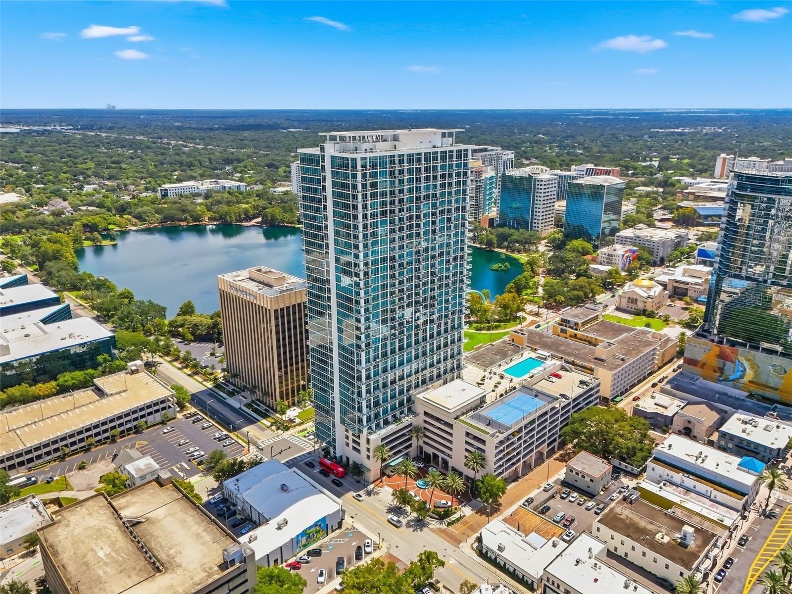 An extraordinary expression of elevated downtown living, Residence #802 at the VUE high rise is a remarkable one-bedroom home overlooking the iconic beauty of Lake Eola. Considered one of the most desirable one-bedroom floor plans in Downtown Orlando, this sophisticated residence has been extensively renovated and thoughtfully upgraded to create a truly exceptional luxury living experience.Wrapped in dramatic floor-to-ceiling windows, the residence showcases breathtaking panoramic views of Lake Eola, the Downtown Orlando skyline, and spectacular sunsets. The expansive windows flood the home with natural light while creating a seamless connection between the elegant interiors and the ever-changing cityscape beyond. For privacy, comfort, and complete control of the ambiance, the residence features fully covering, electrically operated blackout blinds that can effortlessly transform the space at the touch of a button.The interior is defined by a sleek, contemporary aesthetic, with glossy modern tile flooring adding a sophisticated, polished finish throughout. The completely renovated bathrooms feature beautiful modern finishes and premium smart toilets with heated seats, combining refined design with elevated everyday comfort and technology.The newly upgraded kitchen is designed for both luxury and entertaining, anchored by a brand-new Sub-Zero refrigerator and Wolf gas range—iconic names synonymous with exceptional craftsmanship and professional-level performance. A newly installed kitchen island creates an elegant centerpiece while providing additional counter space and an inviting gathering area. The dedicated coffee bar adds another sophisticated touch, creating a beautifully appointed space for morning coffee while enjoying the extraordinary Lake Eola views.The residence also offers an exceptional amount of storage for a one-bedroom home, with built-in closet space and additional closet storage designed to keep everything beautifully organized. The thoughtfully designed floor plan maximizes both living space and functionality while maintaining an open, airy sense of flow. 1 assigned premium parking in the attached gargage. Water heater new 2026. HVAC properly maintained.Residents of The Vue enjoy an unmatched collection of resort-style amenities, including 24-hour concierge service, secured access, a state-of the art fitness center, Relaxing swimming pool, clubroom, boardroom, Cinema room, and fingerprint biometric access to the building. The building is renowned for its luxury lifestyle, contemporary architecture, and exceptional location in the heart of Downtown Orlando. Located just steps from Lake Eola Park, Kia Center, Dr. Phillips Performing Arts Center, Camping World Stadium, Inter and Co Stadium, I-4, 408 highway, Publix Grocery, entertainment venues, nightlife, cultural attractions, and the Central Business District, this exceptional residence offers the ultimate combination of luxury, convenience, and vibrant city living. If you're seeking a full-time residence and executive retreat, Unit #802 presents a rare opportunity to own a piece of Orlando's premier skyline.