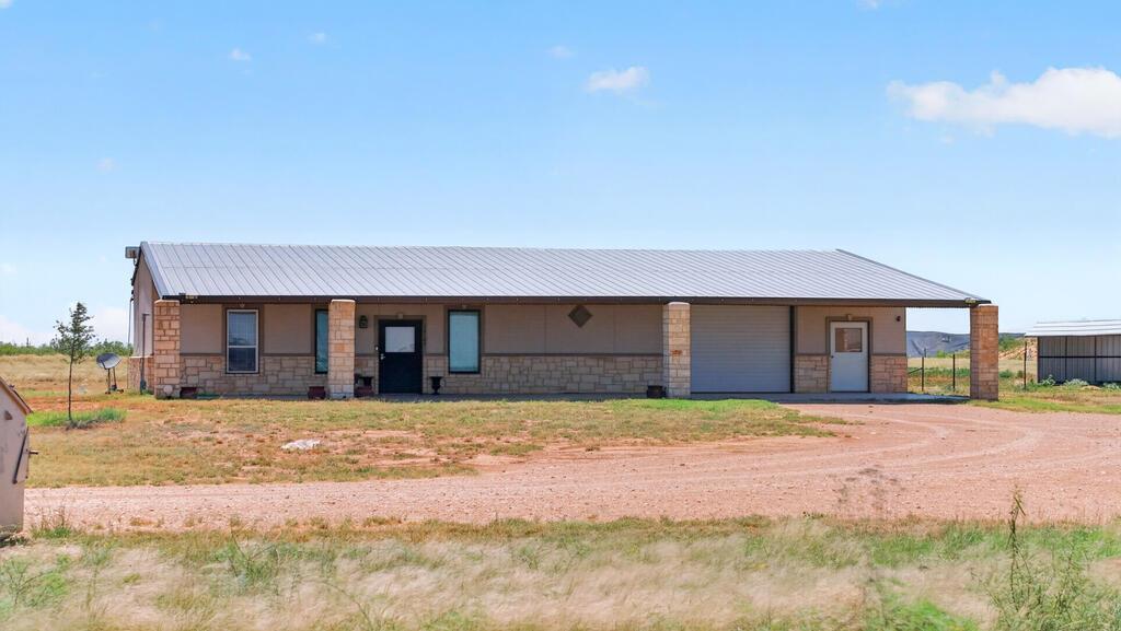 MOVE-IN READY BARNDOMINIUM ON A SPACIOUS LOT! Enjoy open-concept living with stained concrete floors, custom kitchen cabinetry, granite countertops, and a functional layout designed for everyday comfort. The property features a 1,650 SQFT insulated shop with a private office, two RV hookups, a welcoming covered front porch, and horse stalls. The expansive lot offers endless possibilities to build another home, expand, park work trucks or equipment, or create the perfect setup for horses and livestock. Country living with incredible flexibility!