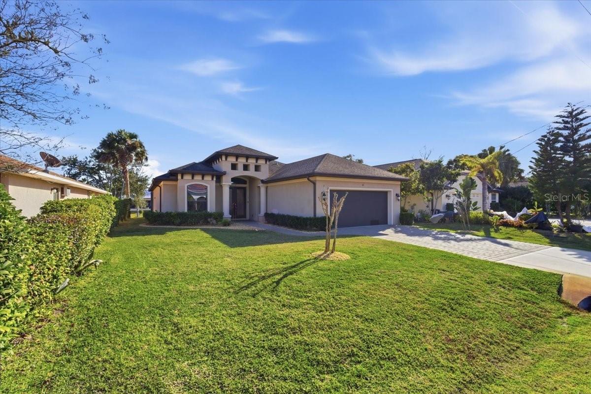 Beautiful solar canal-front home with in-ground pool! This stunning 3-bedroom, 2-bath residence features a large office/den that can easily serve as a 4th bedroom. Built in 2017, the home offers an open split-bedroom floor plan with a spacious foyer and tile flooring throughout—no carpeting.The dream kitchen boasts a large center island with seating, stainless steel appliances, walk-in pantry, and a generous breakfast nook overlooking tranquil canal views. The expansive owner’s suite features a tray ceiling and a luxurious en-suite bath with dual vanities, a corner soaking tub, and a large walk-in shower. Two generously sized guest bedrooms share a well-appointed second bathroom.Step outside to a gorgeous outdoor living area perfect for year-round entertaining, complete with a large in-ground pool and covered lanai. Enjoy low electric bills thanks to solar panels and beautifully landscaped grounds.Ideally located just minutes to the Intracoastal Waterway by boat, minutes to the beach by car, and a short bike ride to miles of scenic biking trails—this home truly offers the best of Florida living.