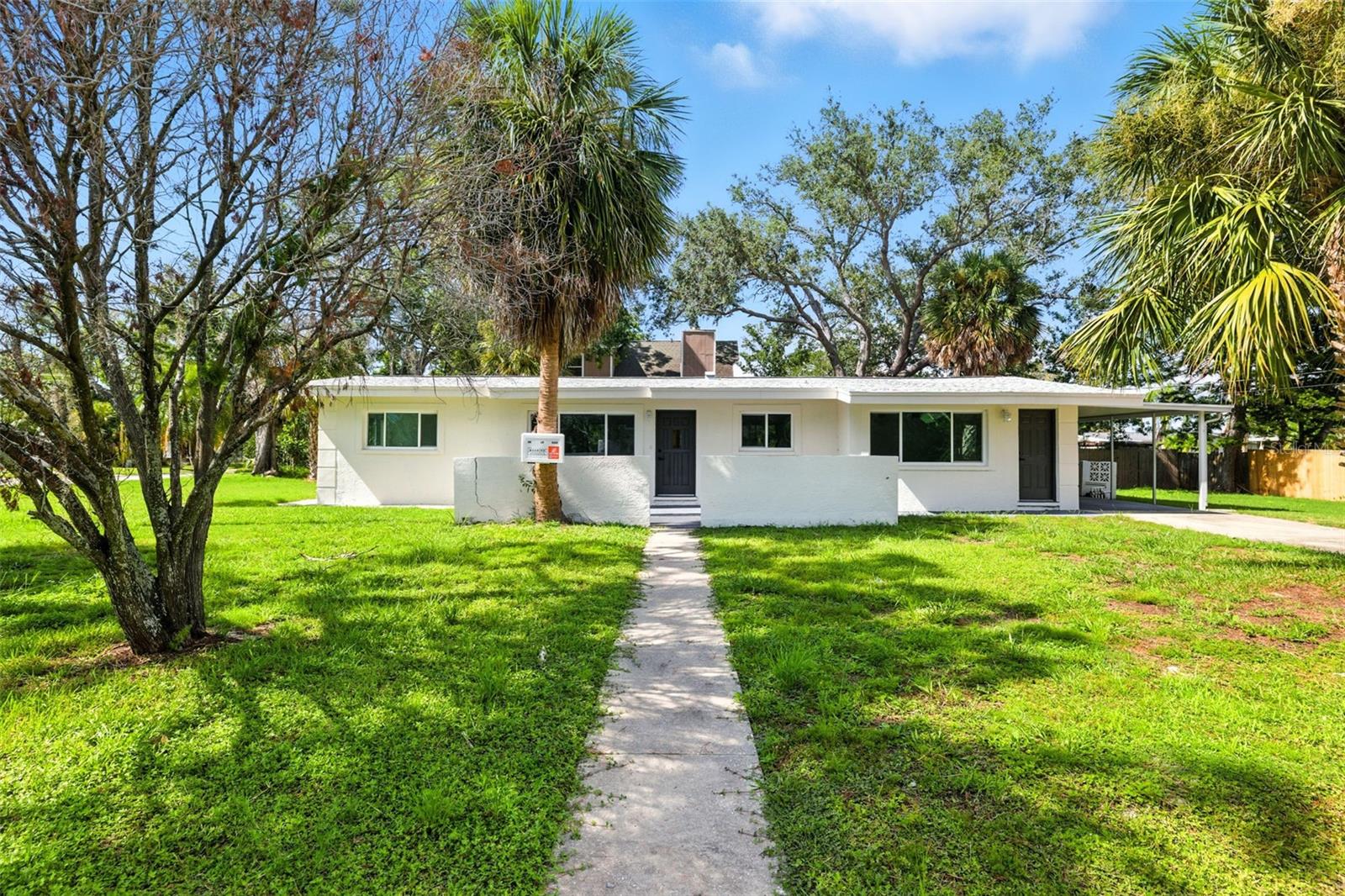 Welcome to 695 Sunset Lane, a fully remodeled coastal retreat tucked away in the heart of Tarpon Springs. This beautifully updated 3-bedroom, 1-bath home sits on a spacious corner lot with a long driveway and 1-car carport, offering convenience and plenty of parking for family and guests. Just minutes from the sparkling Gulf waters and the world-famous Tarpon Springs Sponge Docks, this property is perfect for anyone looking to embrace the Florida lifestyle. The neighborhood is boat-friendly, making it easy to enjoy fishing, boating, and all that the local waterways have to offer.

Inside, you’ll fall in love with the thoughtful upgrades and inviting atmosphere. The home has been freshly painted in neutral colors and features tall ceilings, new luxury vinyl flooring throughout, and an open layout that feels bright and welcoming. The living room is highlighted by a custom accent wall and large sliding glass doors that open to a massive covered lanai, extending your living space outdoors for year-round entertaining.

The gorgeous kitchen is truly the heart of the home, showcasing brand-new cabinetry, granite countertops, a breakfast bar, and stainless steel appliances. Whether you’re preparing a family meal or entertaining friends, this space is both stylish and functional.

The primary bedroom is oversized and split from the secondary bedrooms, offering a private retreat. The fully remodeled bathroom features a new vanity and a charming bathtub with herringbone-patterned tile, adding a touch of elegance and character.

Every detail has been carefully considered to make this home truly move-in ready. With its prime location near shopping, dining, top-rated schools, and just steps from the ocean, 695 Sunset Lane is an incredible opportunity to own a slice of paradise in Tarpon Springs. Perfect as a primary home, vacation getaway, or investment property!

Beyond the home itself, Tarpon Springs offers a lifestyle unlike any other. Known for its rich Greek heritage and historic Sponge Docks, the area is filled with unique shops, authentic Greek restaurants, bakeries, cultural festivals, and waterfront attractions. From exploring the charming downtown district to enjoying boat tours, kayaking, or strolling along the Anclote River, there’s always something to do. Living here means more than just owning a home—it’s about being part of a vibrant community with history, culture, and endless opportunities for fun on the water.