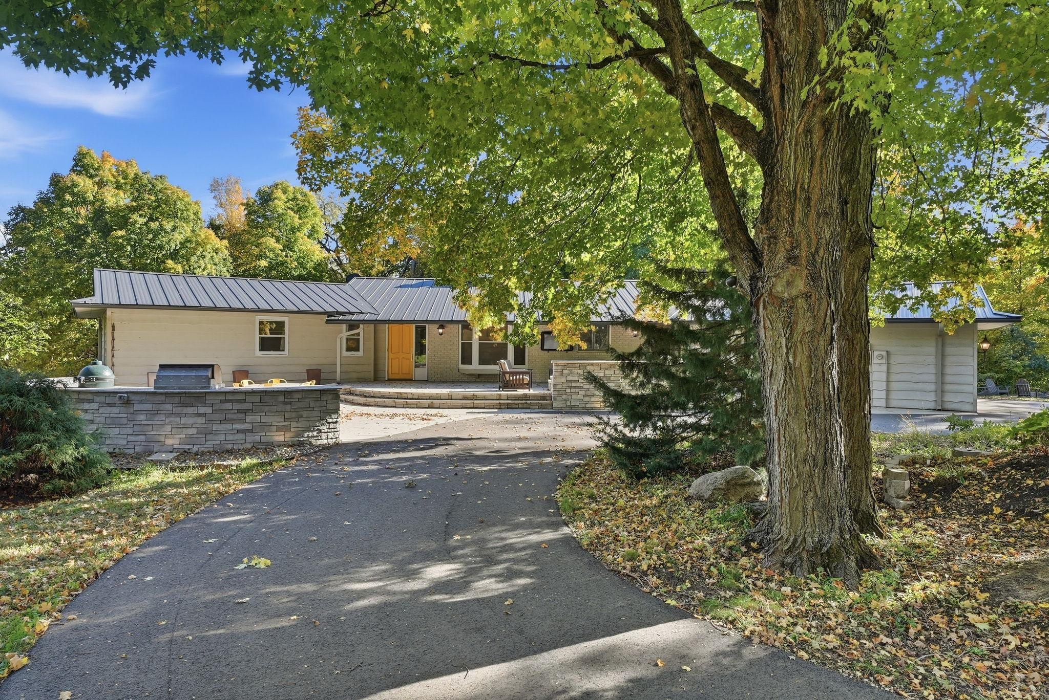 Welcome to 8490 Oak Road – a truly exceptional acreage property where luxury, privacy, recreation and entertaining come together! Located at the end of a quiet cul-de-sac and w/ Sartell, St. Cloud and St. Joseph within shouting distance and 400+ of Watab River frontage, this extraordinary 12.5-acre estate offers 4,000+ finished square feet, a stunning natural setting and an incredible collection of amenities. Located in the highly regarded Sartell-St. Stephens School District, the property features approximately 2,200+ FSF on the main level and 2,100+ SF in the walkout lower level, w/ 5 bedrooms, multiple baths and two kitchens. The main level showcases vaulted tongue-and-groove cedar ceilings, exposed beams and a dramatic floor-to-ceiling brick double-sided fireplace housing three fireplaces—two wood-burning fireplaces on the main level plus a high-efficiency fireplace serving the lower level. The kitchen features custom cabinetry w/ soft-close hardware, an impressive 11.5-foot island, granite countertops and full backsplash, premium fixtures, new Ruvati sound-dampened stainless sinks, glass-front refrigerator, range, Bosch dishwasher and a wall oven. A spacious walk-in butler's pantry includes a sink and beverage refrigerator. The main-level primary suite offers balcony access, generous closet space, an en-suite bath and its own washer. The walkout lower level adds bedrooms, a second kitchen, office/gym, additional laundry, sauna and abundant flexible living space. Three patios and two decks create exceptional indoor/outdoor living,  hot tub area, highlighted by the spectacular 2023 entertaining patio and outdoor kitchen. The 26-foot curved outdoor kitchen features granite countertops, stainless cabinetry, pellet grill, power burner, Big Green Egg smoker and beverage refrigerator, complemented by a commercial 750,000 BTU fire pit, built-in seating, automatic landscape lighting and an accessible ramp. The grounds are equally impressive, w/ mixed hardwoods and evergreens, the Watab River flowing through the southeast portion of the property, a private trail leading to the river and dock, plus lake access to Lake Rassier and Watab Lake. Excellent opportunities for hunting and wildlife viewing, including duck, goose, turkey and deer. Multiple lake association options are available for boat landing, beach and volleyball access, though membership is not required. The property also features a 62x36 heated and insulated shop with air-conditioned office, concrete floors, auto lift and compressor, attached two-car garage, insulated 34x14 stable, 44x18 lean-to, 40x51 pole barn w/ overhead doors, insulated finished 12x12 elevated treehouse w/ covered porch and loft, and a distinctive architectural chicken coop. Stearns County allows up to 10 animal units. Numerous major improvements provide peace of mind, including a standing-seam steel roof, steel gutters and NEW roof/ceiling insulation (2022), NEW asphalt driveway (2024), NEW propane furnace/boiler/hydronic system (2023), NEW water softener and conditioner (2017), central AC (2017), water heater (2015), waterproof Shaw Prodigy HDR Plus LVP flooring (2021), NEW well pump and pipe (2018), and compliant septic system. High-speed internet is available. Wrapped in wavy-bevel, natural-edge, solid-stained cedar siding and surrounded by remarkable natural beauty, this one-of-a-kind property offers an unparalleled combination of privacy, recreation, entertaining space and comfort. Do not miss out on your chance to call this place home!