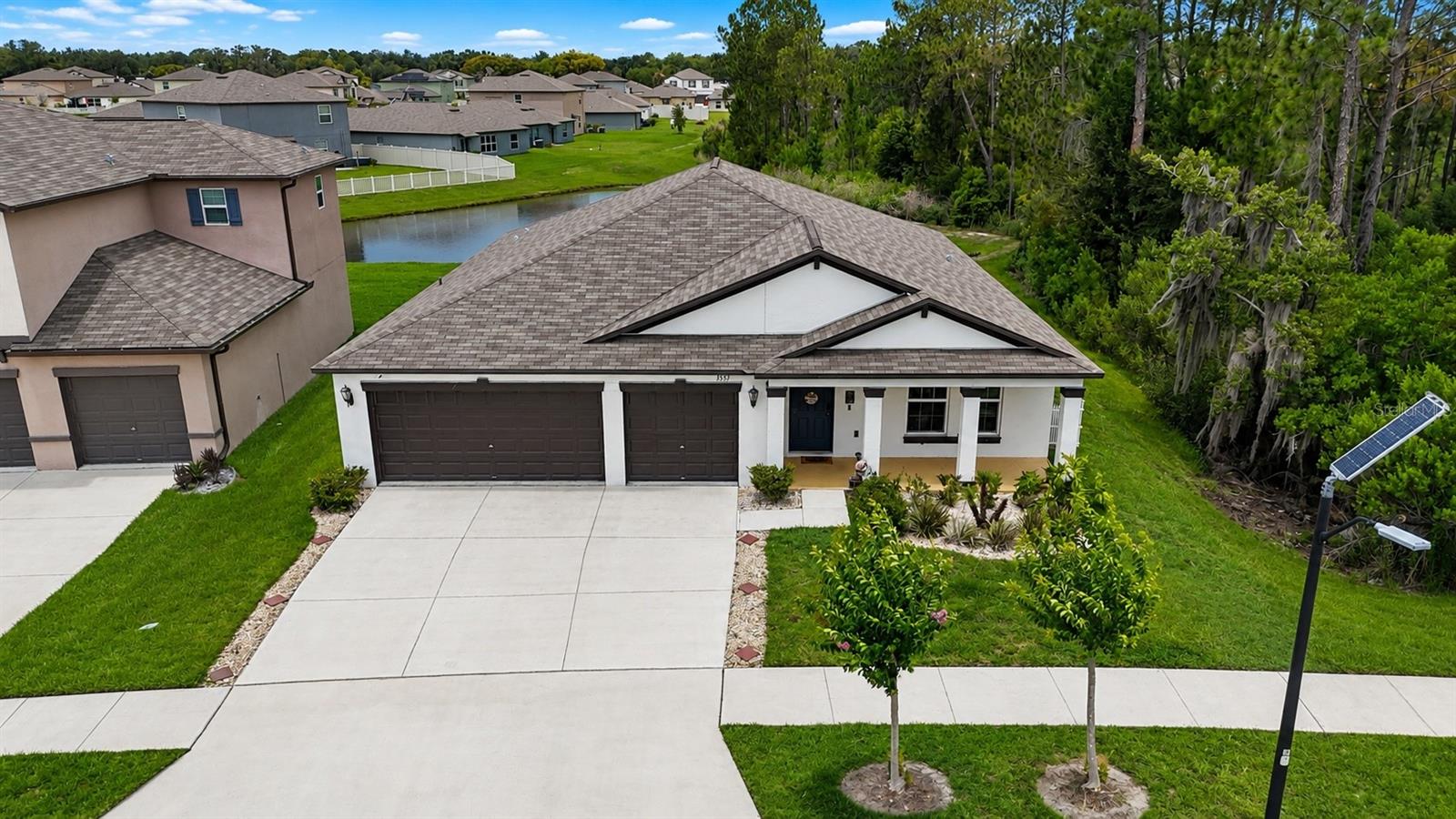 Welcome to North Park Isle! This like-new 4-bedroom, 2-bathroom home offers a spacious open-concept design perfect for both everyday living and entertaining. Step inside to find tile flooring throughout the main living areas and comfortable carpeting in all bedrooms.The heart of the home features a seamless family room, dining area, and kitchen combination. The well-appointed kitchen boasts a large center island with additional seating, ample counter space, and abundant cabinetry, making meal preparation and gathering with family and friends a breeze.The spacious primary suite provides a private retreat with a walk-in closet and an en-suite bathroom featuring dual vanity sinks and a tub/shower combination. Three additional bedrooms share a full bathroom, offering flexibility for family, guests, or a home office.Additional features include a convenient indoor laundry room and a spacious 3-car garage, providing ample storage and parking space.Sliding glass doors from the family room open to a large backyard overlooking a peaceful pond, creating the perfect setting to relax, entertain, or enjoy Florida's beautiful weather. Conveniently located near shopping, dining, major roadways, and everyday conveniences, this move-in-ready home combines comfort, style, and an excellent location.