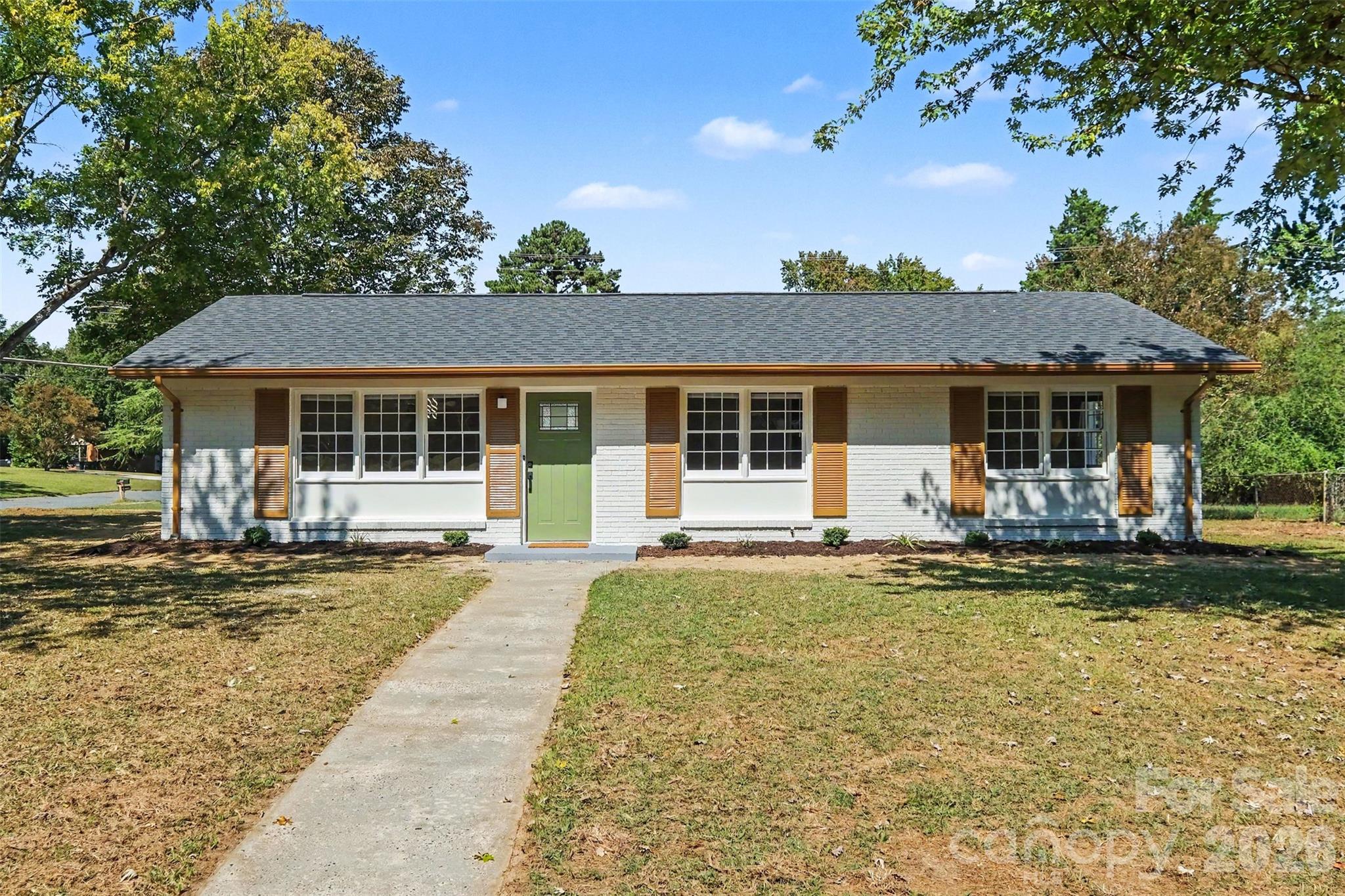 Welcome to 3801 Hillock Ct, a beautifully renovated, move-in-ready brick ranch combining modern design, extensive updates, and a convenient Charlotte location. Situated on a spacious corner lot, this home offers generous outdoor space plus the added flexibility of side access and ample parking.Step inside to a bright, inviting interior featuring fresh neutral paint, new cohesive vinyl flooring, updated interior doors, recessed lighting, and contemporary fixtures throughout. The open living area flows seamlessly into a beautifully redesigned modern kitchen, the home's ultimate centerpiece. Enjoy brand-new cabinetry with elegant gold-tone hardware, white quartz countertops, a large contrasting center island, a farmhouse-style sink, a new range hood, and stainless steel appliances, including a refrigerator, dishwasher, microwave, and range. Stylish pendant lighting completes this modern and functional space.Both full bathrooms have been completely renovated with new vanities, fixtures, tilework, and contemporary finishes.The guest bath offers a pristine tiled tub surround, while the primary bathroom showcases dramatic floor-to-ceiling dark porcelain tile for a true spa-like experience.The improvements extend well beyond the cosmetic updates. The home features a new roof with new plywood, new gutters, fresh exterior paint, new exterior doors, a new heat pump HVAC system with furnace, and a new 2026 water heater. Transferable warranties are available for the heat pump and water heater, adding additional value for the next owner.Outside, the classic brick exterior is complemented by a generously sized corner lot with mature trees, substantial front and backyard space, and additional parking flexibility along the side of the property. Rear sliding doors provide convenient access to the patio and backyard, creating an easy connection between indoor and outdoor living.Location is another standout feature. Set on a spacious corner lot with mature trees and generous outdoor space, the property offers a welcome sense of openness and privacy while keeping you conveniently connected to the heart of Charlotte. Enjoy the best of both worlds—more room to spread out at home, yet just approximately 3.7 miles from NoDa, 3.9 miles from Plaza Midwood, and 6.4 miles from Center City Charlotte. Restaurants, coffee shops, entertainment, local businesses, and some of Charlotte’s most vibrant walkable districts are only a short drive away.With a stylish renovation, major system updates, a spacious corner lot, flexible parking, and a location that combines breathing room with convenient city access, 3801 Hillock Ct offers much more than a beautiful interior.  Come see it for yourself and make this home yours.