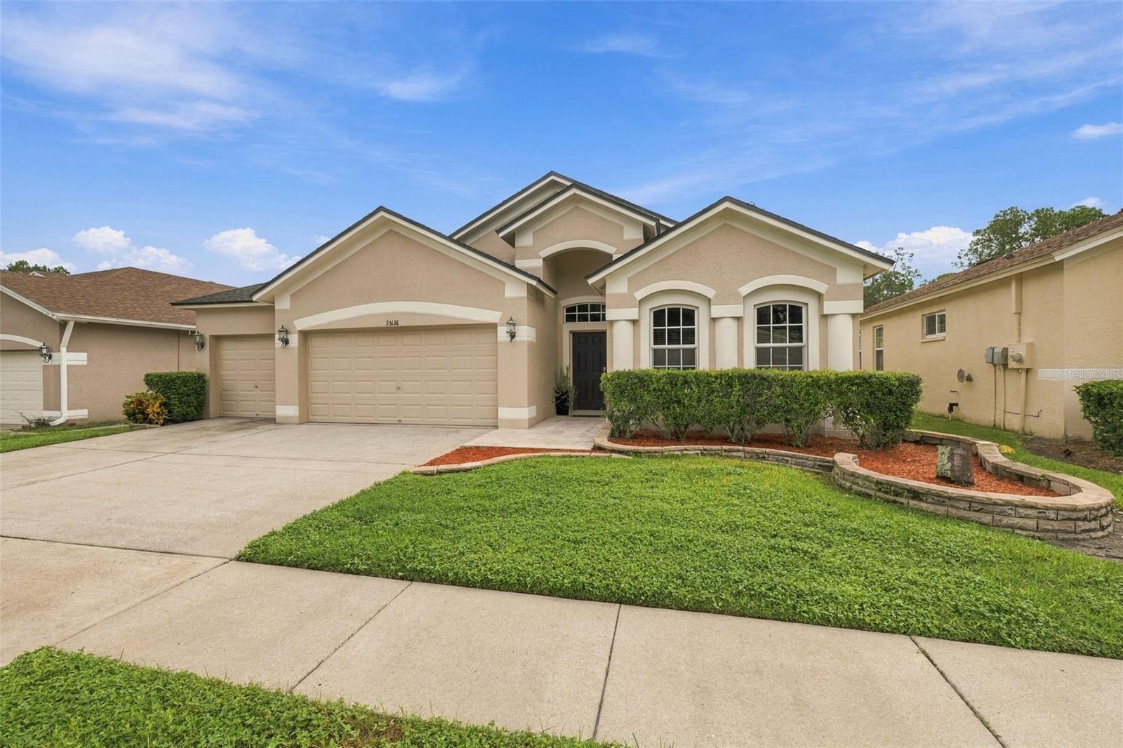 Welcome to this beautifully maintained 4-bedroom, 2-bath, one-story home with a 3-car garage and tranquil pond views in Zephyrhills! Offering 2,080 square feet of living space on a 6,747-square-foot lot, this spacious home combines an open floor plan, thoughtful upgrades, and exceptional indoor-outdoor living. The inviting entry features a transom window and tile flooring, leading into the living and dining areas with beautiful bamboo flooring. The open kitchen features Corian countertops, glass tile backsplash, double sink, closet pantry, recessed lighting, breakfast area, and included LG refrigerator with ice and water, GE range, microwave, and dishwasher.The spacious family room features wiring for surround sound and opens through triple sliding glass doors to the covered patio and private backyard. The fully fenced yard offers beautiful pond views, irrigation, landscape curbing, rear gutters, PVC fencing, and an impressive outdoor kitchen with a built-in propane grill, creating an ideal space for entertaining or relaxing.The spacious primary suite features a garden tub, dual-sink vanity, tiled shower with spa shower system, frameless glass enclosure, and walk-in closet with custom organizers. Three of the four bedrooms feature closet organizers. The second bathroom offers a tub/shower combination with glass doors and a convenient storage niche. Major updates provide peace of mind, including a NEW HVAC system installed in 2026 and a roof installed in February 2025. Solar panels were installed in March 2018 and contribute to energy efficiency and potentially lower electric costs. Additional features include 10-foot ceilings in the main living area, recessed lighting, interior laundry room with included Kenmore washer and dryer and additional shelving, and a spacious 3-car garage with two garage door openers and a laundry sink.The community offers an exceptional array of recreational amenities and activities for residents to enjoy, including a fitness center with locker rooms, resort-style swimming pool and cabana, playground, picnic area, lighted tennis courts, basketball courts, pickleball courts, and a variety of community events and activities. All of this is available for a low HOA fee of just $159 per quarter, adding tremendous value to this wonderful Zephyrhills home. With its newer roof, brand-new HVAC, solar panels, 3-car garage, pond views, outdoor kitchen, spacious fenced yard, and outstanding community amenities, this home offers an exceptional combination of comfort, functionality, and lifestyle! X Flood Zone and No Flood Insurance is required.  Please inquire about special financing option through Regions Bank for Qualifying Homebuyers-6.125% Interest Rate, $10K Grant (doesn't need to be paid back) and 100% Financing with No PMI!