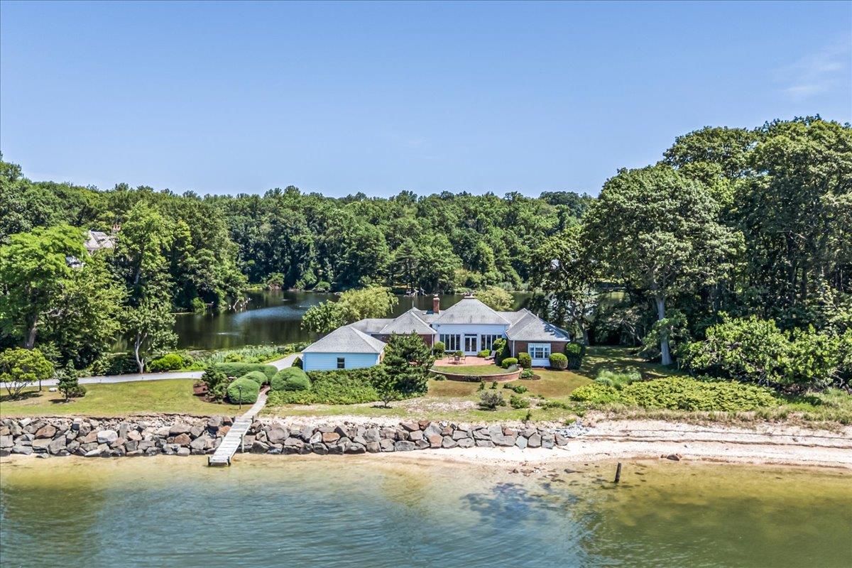 One-of-a-kind Waterfront Living in Lloyd Neck

Situated on one of the North Shore’s most spectacular sites, this extraordinary 4.6-acre property is surrounded on two sides by breathtaking water vistas—including 175 feet of unobstructed frontage on Cold Spring Harbor and a peaceful freshwater pond. Reached by a private road and a 150-foot bluestone driveway, the residence is nestled within beautifully landscaped grounds that offer exceptional privacy and serenity. This fabulous, ranch-style home features 4 bedrooms, 3.5 baths, offers soaring ceilings, and refined architectural details throughout.  The formal dining room is anchored by a charming fireplace with Delft tile surround, contributing warmth and character to the home’s timeless appeal.  Expansive brick patios invite seamless indoor-outdoor living, and a 3-car garage adds convenience. Enjoy panoramic western water views, glowing sunsets, and your own deeded beach—an unparalleled opportunity to experience the very best of waterfront living.  Cold Spring Harbor SD#2.  Lloyd Harbor Village Park, Beach, Tennis & Mooring (Dues Required).