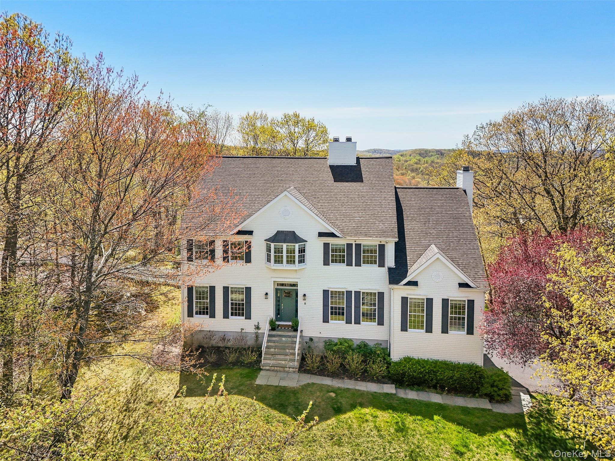 SPECTACULAR SUNSET VIEWS. Fabulous high site with breathtaking distant views. Classic Country Colonial with high ceilings, substantial millwork, crown moldings and hardwood floors. Bright and airy interior with beautifully scaled rooms. Center Entrance Hall with French doors to Living Room and formal Dining Room. Well-designed Kitchen with white cabinetry, granite counters, center island, pantry and breakfast area with doors to the deck. Perfect for today’s lifestyle, open Family Room with fireplace. Large Office perfect for working remotely. Spacious Primary Suite with large Bedroom with door to Juliet balcony, ample Walk-in Closet and private Bath. Three additional Bedrooms. Walk-out Lower level with second Office, Recreation Room with Gym and seating area with woodburning stove. Central air and automatic generator. Fenced for deer, 1.52 acres in an established neighborhood. Beautifully landscaped grounds with specimen trees and mature shrubs. Stone steps surrounded by wildflower gardens lead down to large flat playing field. Deeded lake rights to Lake Hawthorne. An incredible offering!