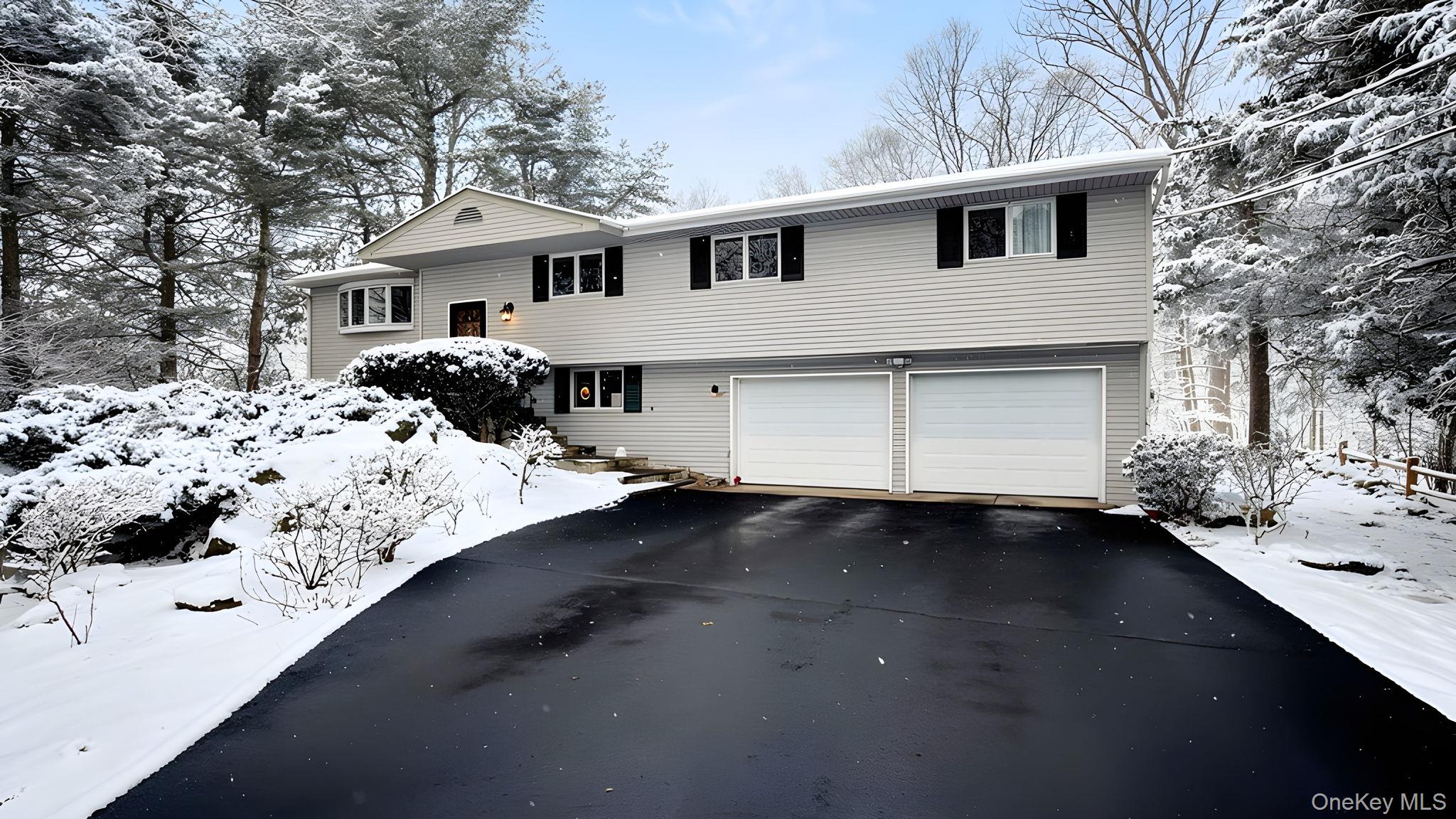 Welcome to 29 Meadow Lane, ideally tucked away on a quiet, picturesque cul-de-sac in the heart of Chappaqua. Set on over half an acre of beautifully landscaped, private property, this fully updated ranch offers flexible living, modern comfort, and an exceptional location. Sidewalk-lined streets lead from the neighborhood into bucolic downtown Chappaqua, just minutes from shops, dining, and the Metro-North train. The property features a level, usable yard that offers the perfect balance of privacy and open green space for outdoor enjoyment. The sun-filled main level features a spacious living room, dining area, and updated kitchen with stainless steel appliances, flowing seamlessly into a three-season sunroom and out to an open deck perfect for relaxing or entertaining. Four bedrooms, including a primary suite with en-suite bath and a full hall bathroom, complete the main level. The lower level offers incredible versatility with an expansive family room with patio access, a den, half bath, laundry room, and a private office or guest bedroom, allowing the home to easily live as five bedrooms. Freshly painted throughout, major upgrades within the past four years include the kitchen, baths, recessed lighting, roof, HVAC system, and repaved Belgium block-lined driveway. The lower level and sunroom were renovated in 2026. An attached two-car garage completes this move-in-ready home. Sunday open house CANCELED due to weather.