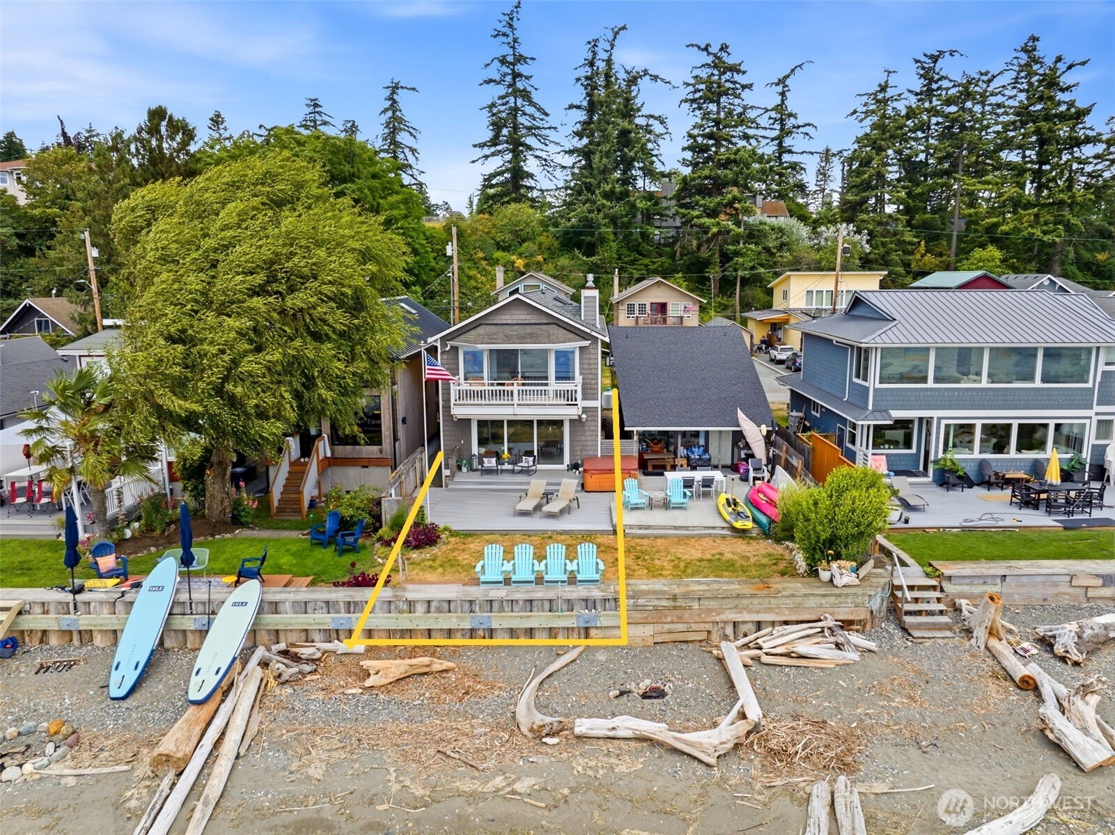Rare opportunity in coveted Juniper Beach, where waterfront homes are seldom available. This 2BR+/2BA, 2,102 SF beach home offers expansive shoreline access where the beach stretches for what feels like miles at low tide—perfect for beachcombing, kayaking, paddleboarding, and embracing the island lifestyle. Camano Island offers the convenience of easy, no-ferry access via bridge while maintaining the peaceful charm of island living. Features include oak hardwood floors, slab granite countertops, maple cabinetry, stainless refrigerator, dining built-ins, and a mid-century hall bar. The main-level family room with propane fireplace opens to a spacious deck overlooking the bulkheaded waterfront. Upstairs, the primary retreat features a fireplace, skylights, soaking tub, tiled shower, dual vanity, flexible sitting or office space, private view deck, and upstairs laundry. Additional highlights include Cemplank siding, side storage, and a 2-bedroom septic system. Also available with the neighboring residence MLS #2549246 as a combined offering under a separate MLS listing, MLS #2549244.