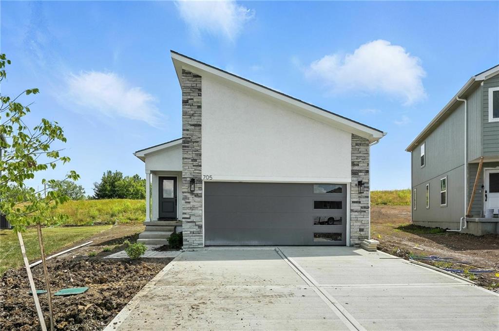 Welcome to the “Sunflower” ranch plan, where simplicity and sophistication converge in a 2-bedroom, 2-bath layout designed for effortless main-level living on a cul-de-sac lot backing to green space and privacy.  Step into the radiant charm of this timeless home, featuring vaulted ceilings throughout, enhancing the sense of spaciousness and airiness in every corner. Embrace the warmth of natural light streaming through abundant windows, creating a bright and inviting atmosphere throughout the open living spaces. Perfectly suited for those seeking ease and comfort, the “Sunflower” floorplan offers a seamless blend of functionality and style, making it the ideal sanctuary to call home.  If additional space is needed, why not finish the lower level with an additional bed, bath, and rec room or customize into your own dreamscape living area.  Eastbrooke at Creekmoor has it all!  Designed around 108 acre Lake Creekmoor and the acclaimed 18 Hole Championship Golf Course, Creekmoor offers one of the most comprehensive residential amenities packages available, where homeowners with both active and relaxed lifestyles enjoy what feels like vacation all year long.  Pools, tennis, pickleball, basketball, 24-hour fitness center, golf pro shop, Tavern on the Moor restaurant and bar, fishing, boating, SUP, and still more...it's ALL here!  With an abundance of shops, restaurants and services minutes away and with easy access to Jackson and Johnson Counties, homeowners have all the benefits of metro living at their fingertips while enjoying home life outside the hustle and bustle. Whether making your first home purchase or your last, this is a destination community like no other.  Please follow directions in listing as streets are still new.
