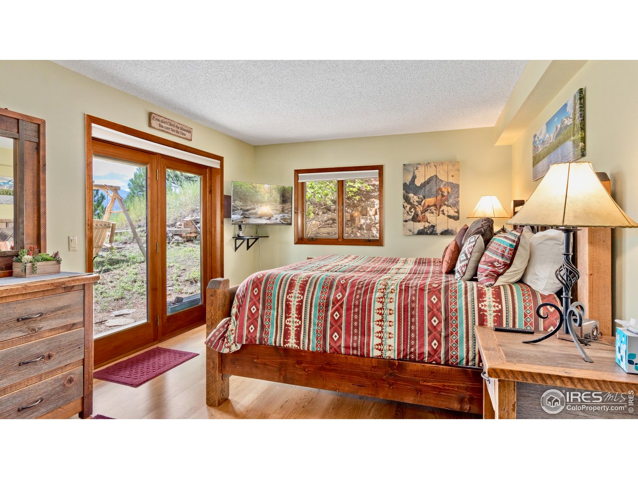 Outrageous, unrivaled panoramic mountain views from every room of this beautiful active, successful, revenue-producing STR vacation rental mountain condo. Located high on Ram's Horn Mountain in the highly coveted residential luxury residential mountain enclave of Windcliff Estates, this lower unit offers approximately 1,872 square feet over two levels of comfortable, self-contained living space within a stand-alone over/under duplex condo. With panoramic Continental Divide views and a layout well suited to rental or guest use, this property presents an excellent opportunity for income-focused buyers or those seeking flexible mountain living. The living area is anchored by a gas fireplace, providing convenient warmth and inviting ambiance. The floor plan allows the unit to function independently, making it ideal for short-term rental operation, extended family use, or as a complementary residence when paired with the upper unit. Short-term rentals are permitted and codified by HOA rules and Larimer County zoning. Its size, configuration, and location support continued rental use or personal enjoyment.Additional Opportunity: The upper residence in this duplex is also available for purchase. Together, the two homes may be operated as a combined 6-bedroom short-term rental that legally sleeps up to 16 guests, creating a rare, large-capacity rental asset with panoramic mountain views. Purchased on its own or in combination with the upper residence, this property offers unmatched panoramic views, comfort, flexibility, income potential, and a prime elevated setting in the Estes Valley.