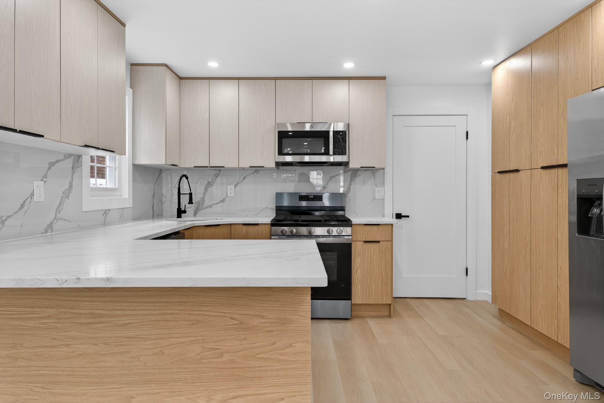 Space, style & modern luxury come together at 145-03-123rd Avenue! A meticulously renovated, turn key, move in ready, fully detached single family. Situated on a beautiful tree lined street of the Jamaica/ South Ozone Park Border. Perfect Starter home for first time buyers! As you enter you are greeted by an expansive sun drenched, modern, open concept living/dining area. Equipped with LED lights, Acoustic Wall Panels and designer fireplace. Towards the rear of the property the elegant kitchen any chef will love awaits you. Kitchen features floor to ceiling custom cabinetry, adorned with a full fleet of stainless steel appliances, and equipped with island for bar stool seating, and built in pantry. Powder room and designated laundry room on first floor as well. Up a flight of stairs onto the second floor 3 spacious bedrooms awaits you, each equipped with ample closet space. Down the hall a fully tiled bathroom is adorned with state of the art wall & floor tiles and provides spa like feeling. The high ceiling full finished basement can be used as the perfect in-law suite, media den, home office, storage space or additional recreational space. Renovations include select wood flooring, recessed lighting, updated electrical, heating, plumbing and energy efficient central A/C Systems throughout. This turn key, move in ready single family is conveniently located with close proximity to major transportation which makes commuting a breeze. Short blocks to Rockaway Blvd, Van Wyck Expressway, JFK airport, Airport Hotels, JFK Cargo Section, schools, shopping centers, restaurants, parks, cafes and many other vibrant neighborhood amenities.
