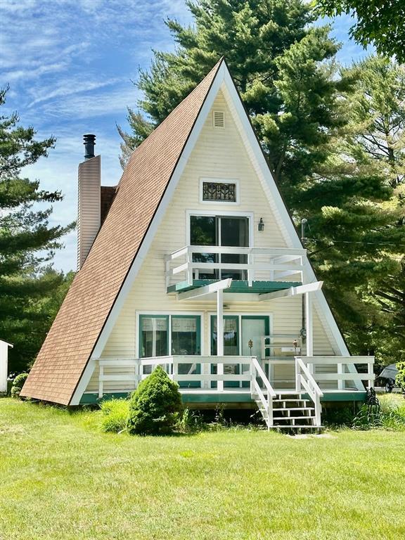 Are you looking for space? This lot has plenty! At roughly 56' x 505', and neighbors with equally deep lots, there is room to expand with a garage or pole barn, if desired. At over 1215 sq.ft., this cute A-frame has two large sleeping areas, one bathroom and a large 22'x15' living room with a tall open ceiling featuring a cozy wood burning fireplace. This large room is open to the dining area that looks out to the lake. Move out one of the two door walls onto the 12'x16' deck to enjoy the lake view and for grilling and picnicking. Moving upstairs, the lower of the two sleeping areas provides an ample 14'x10' space with another door wall opening onto a 10'x8' second level deck. Move up just 5 or 6 steps to another 16'x15' sleeping area with room for several beds. Lots of sleeping room for children and/or grandchildren!!! Memories!!!