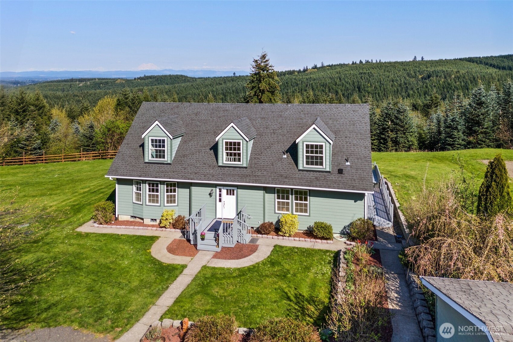 Breathtaking mountain views on just under 5 acres! This spacious 3 bed, 3 bath home includes a den, two living areas, and a bright, beautiful kitchen perfect for entertaining. Enjoy brand-new flooring throughout and mature landscaping that offers privacy and charm. The property features a two car detached garage plus a large shop with a lean-to, ideal for hobbyists or professionals—equipped with a 9,000 lb 2-post lift, 2-stage air compressor, insulated walls, and RV hookups. A rare find with room to live, work, and play in one stunning location!