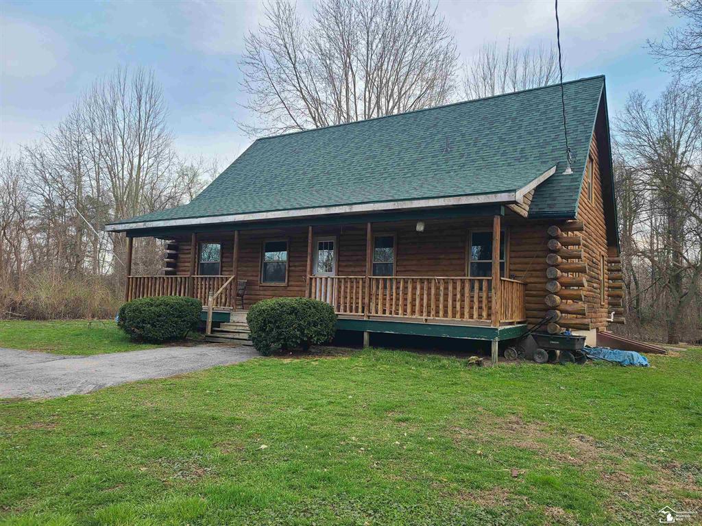 Escape to your own private retreat with this charming log cabin with rustic charm nestled on 5.1 wooded acres in Monroe!  This 2-bedroom, 2 full bath log cabin is tucked away among mature trees offering privacy.  Surrounded by nature, this property is perfect for those who love peaceful surroundings, wildlife, and the beauty of all four seasons.  If you love to hunt, this is it, wake up and walk into your own woods.   Step inside to a warm and inviting interior featuring natural wood flooring, wood burning fireplace, and an open living space that captures the essence of cabin living.  The top loft bedroom is very spacious, perfect for hosting guests or just enjoying it yourself.  The main floor bedroom has a master bath.  Enjoy morning coffee on the back screened in porch.  A place where you can truly make it your own-inside and out.  Water is being hauled in.  Buyer's agent to verify ALL info.