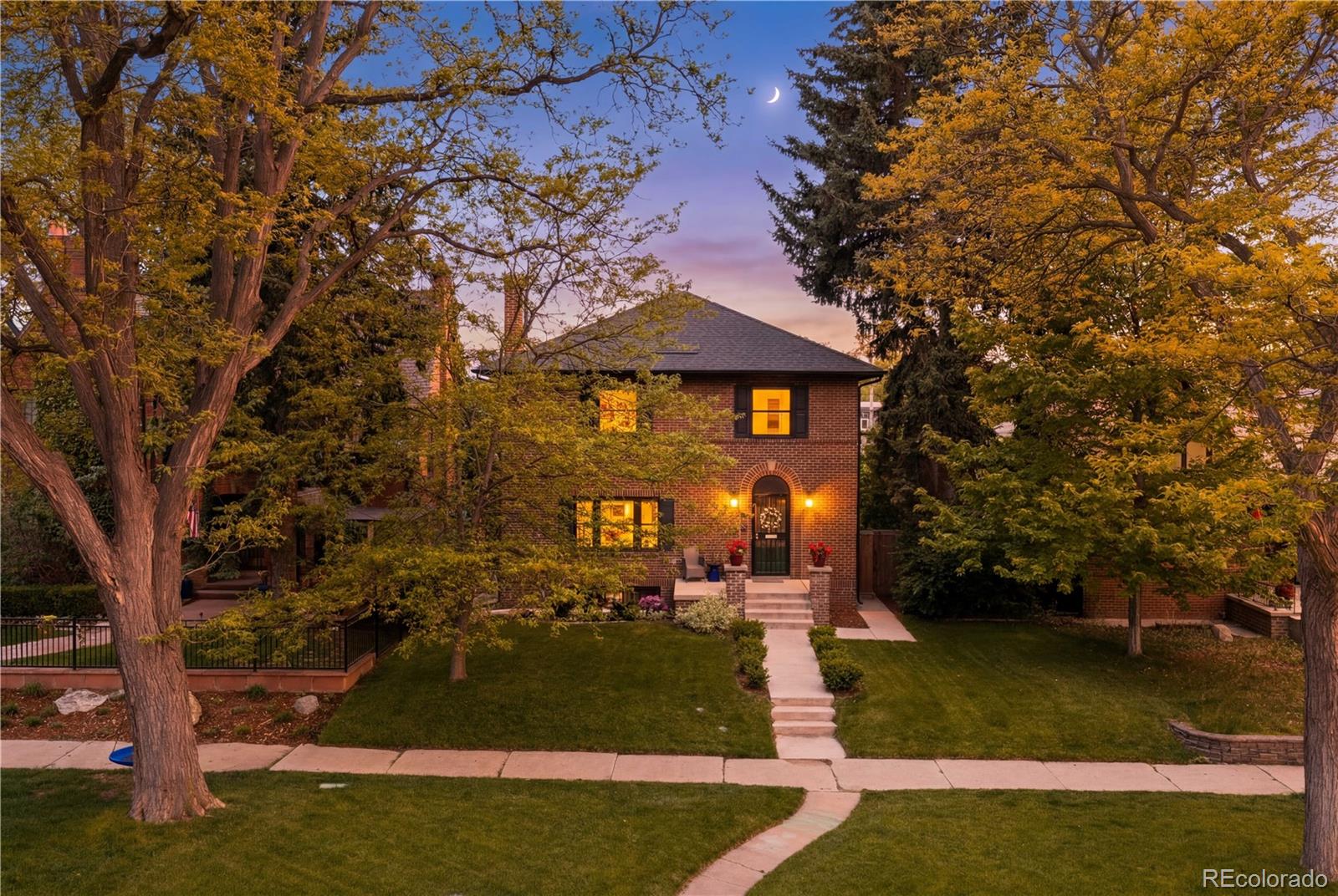 Exceptional craftsmanship and design come together in this stunning Park Hill residence on historic Montview Boulevard - a street where opportunities to own are rare. Built in 1926, this historic home blends timeless character with modern luxury. Fully remodeled in 2021 (including a new roof, HVAC systems, kitchen, windows, plumbing, electrical, sewer line, expanded gas line, and later-added solar panels), the home was also structurally expanded to include a spacious second-floor primary suite, inviting main-floor family room, and oversized detached three-car garage. Inside, the bright open-concept layout is designed for both everyday living and entertaining. Large gathering spaces flow seamlessly to the backyard oasis, professionally landscaped in 2022 with an expansive stone patio, pergola and hot tub perfect for relaxing or hosting guests. The beautifully updated kitchen is a true standout, featuring quartz countertops, bar seating, high-end appliances installed in 2021, and a generous dining area. Upstairs, three secondary bedrooms and a full bath accompany the impressive primary suite, complete with a spa-inspired five-piece bath and custom walk-in closets added in 2022. The fifth bedroom is currently used as an office/laundry room and is easily adaptable as a nursery, fitness room, or creative space - basement laundry hookups mean the choice is yours. Additional updates include upstairs wood flooring to match the original hardwoods downstairs, custom window blinds (2021), water softener (2025), and basement carpet (2025). The basement provides additional living space with a cozy family room featuring a fireplace, bedroom, 3/4 bath, and storage. Perfectly located within walking distance of City Park, the Denver Zoo, the Museum of Nature & Science, the Park Hill Library, farmers markets, City Park Jazz, neighborhood restaurants and cafés. A rare opportunity to own a turnkey home on the premier boulevard anchoring one of Denver’s most sought-after neighborhoods.
