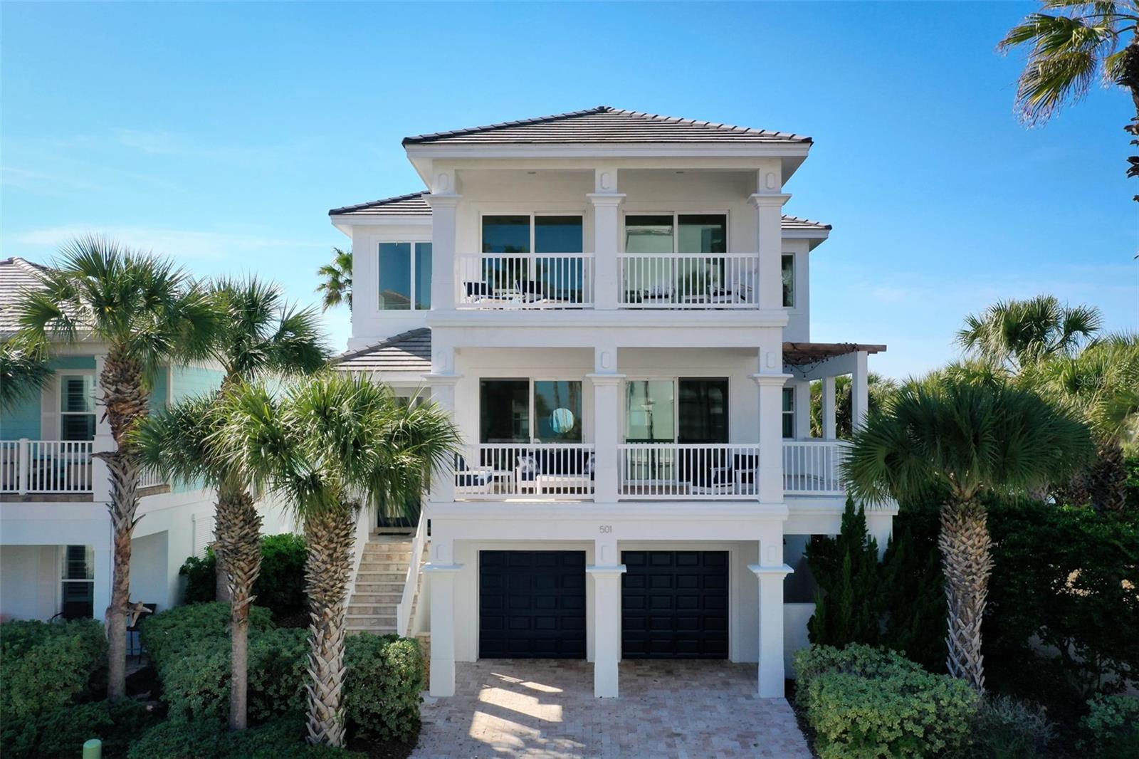 Experience coastal luxury at its finest in this beautifully renovated beachside residence located at 501 Cinnamon Beach Lane in the highly sought-after community of Cinnamon Beach community at Ocean Hammock. Ideally positioned directly across from the beach walkover and just steps from the community's resort-style amenities, this exceptional six-bedroom, five-and-a-half-bath home offers the ultimate blend of modern elegance, functionality, and relaxed coastal living. Extensively remodeled in 2025, the home showcases sophisticated finishes and thoughtfully designed living spaces across three levels, all connected by a private elevator. The stunning renovated kitchen serves as the heart of the home, featuring custom white cabinetry, quartz countertops, stainless steel appliances, a striking coastal-inspired tile backsplash, and an expansive island perfect for gathering and entertaining. Open-concept living and dining areas are filled with natural light and seamlessly extend to outdoor living spaces, including a front balcony with ocean views and refreshing sea breezes. Designed to comfortably accommodate family and guests, the home offers six spacious bedrooms. The second floor includes a guest suite with a king bed and full bath, while the third-floor retreat features the luxurious primary suite complete with a private balcony, spa-inspired bath with soaking tub, walk-in shower, dual vanities, and peaceful views accompanied by the sounds of the Atlantic Ocean. Three additional guest bedrooms are also located on the upper level, creating a dedicated private retreat for family and visitors. A sixth bedroom on the first floor provides additional flexibility and privacy. The first level is designed for entertainment and relaxation, featuring a spacious recreation area with a wet bar and beverage refrigerator, and direct access to the backyard oasis. Outside, enjoy your own private tropical retreat with a heated resort-style pool and spa surrounded by lush landscaping and expansive paver decking. An outdoor shower, multiple balconies, and generous outdoor living spaces further enhance the home's coastal appeal. Residents of Cinnamon Beach enjoy exclusive access to exceptional amenities, including oceanfront and lakeside pools, a fitness center, game room, seasonal café, private beach access, and miles of pristine Atlantic coastline. Whether you're seeking a primary residence, luxury vacation home, or exceptional rental property, this turnkey coastal retreat delivers an unparalleled Florida lifestyle in one of Palm Coast's premier oceanfront communities. Excellent rental history through Cinnamon Beach Vacations! Ask about rental program incentive. Don't delay!