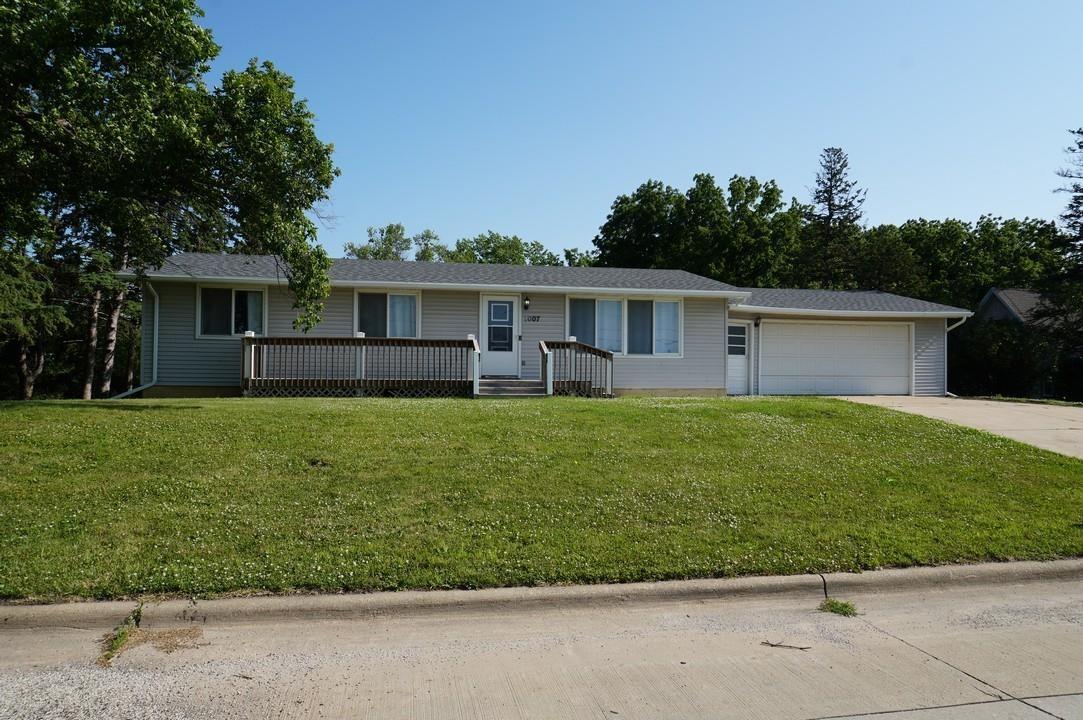 Modern 3-bedroom, 2-bathroom home with a picturesque backyard! This 1,344 sq ft ranch-style home sits on the edge of town, offering a beautiful 0.868-acre lot bordered by mature trees. The home is full of fresh finishes with new paint, flooring, and fixtures throughout. New roof, soffit, and gutters. The large living room opens to the updated kitchen and dining area with new cabinets, countertops, and appliances. Laundry with ½ bath is tucked off the kitchen. An enclosed porch provides space to relax or entertain with backyard views. Down the hall are 3 nice sized bedrooms and an updated full hall bath. The full basement has walk-out access to the backyard and is perfect for storage or can be finished to suit your needs. There is also an attached 2 car garage (24 ft x 24 ft) with ample space for parking and storage. This house is ready to be your new home!