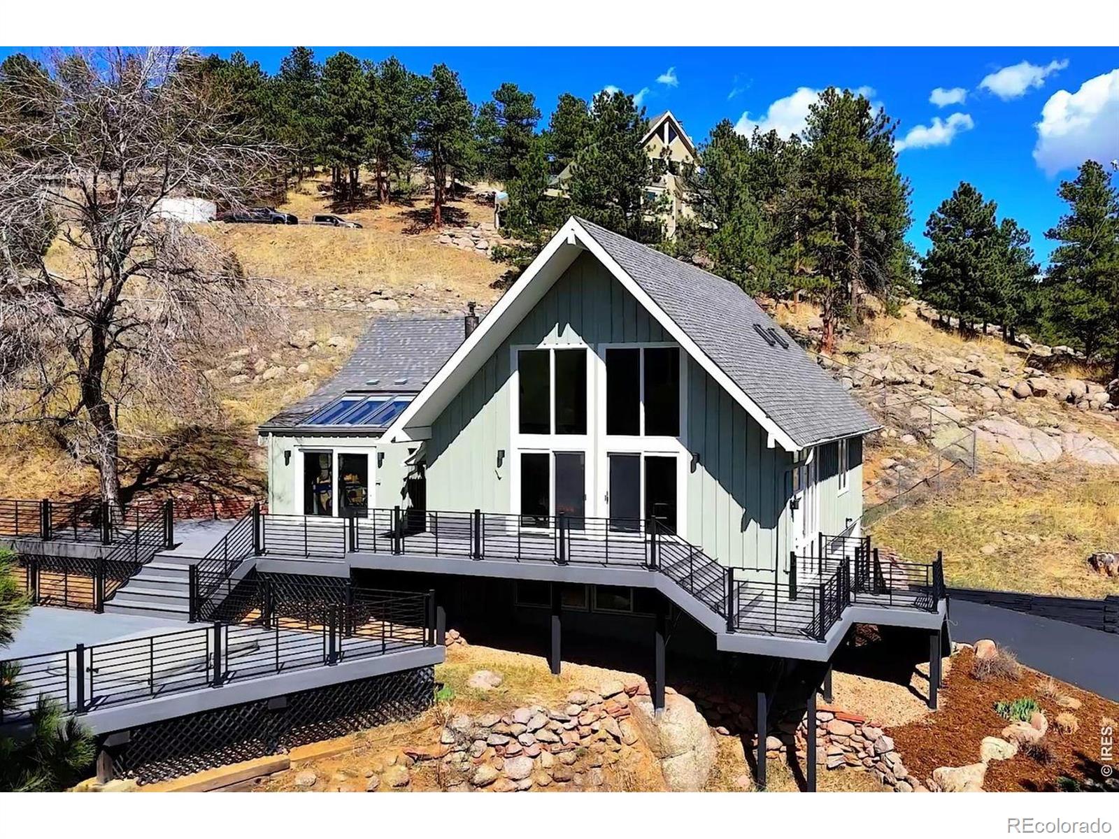 Serene mountain retreat just minutes to the heart of downtown Boulder. Scenic views from every room. Stunning and extensive remodeling featured in this architecturally gorgeous home. High end amenities- Custom cabinetry and tile work, solid surface countertops, and much more. Three bedroom suites, each offer a private bath plus an additional guest bathroom. Impressive living room with large updated windows, soaring ceilings and stone fireplace. Spacious family room with builtins, fireplace and vaulted wooden ceilings. Beautiful hardwood flooring throughout most of the main level. Vast outdoor living space with over 1500 square feet of updated high end composite decking and hot tub. Enjoy the stone patio area off the family room for additional outdoor space. 2 car garage and storage shed. Very private 1.98 acres including almost an acre that is fenced. Pine Brook Hills offers natural gas and it's own water source and reservoir. Only 4 miles to enjoy all that downtown Boulder has to offer. Dining, shopping theatre and more for that perfect mix of mountain living and city conveniences.