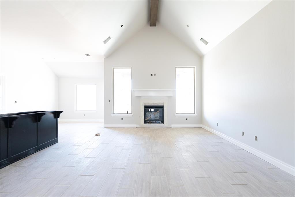 This Blue Spruce Bonus Room 1 floor plan includes 2,640 Sqft of total living space, which features 2,350 Sqft of indoor living and 290 Sqft of outdoor living space. There is also a 590 Sqft, three car garage with an in-ground storm shelter installed. This home offers 4 bedrooms, 3 full baths, 2 covered patios, a large bonus room, and a utility room. The great room welcomes a pristine cathedral ceiling with a ceiling fan, excellent wood-look tile, rocker switches throughout, Cat6 wiring, and large windows. The kitchen supports stainless steel appliances, a 5-burner cooktop, 3 CM countertops, a center island with a trash can pullout installed, well-crafted cabinets to the ceiling with under cabinet lighting and cabinet hardware installed throughout, exceptional pendant lighting, and a separate walk-in pantry. The primary suite features a sloped ceiling with a ceiling fan, windows, and our cozy carpet finish. The attached primary bath hosts separate vanities with framed mirrors, a European walk-in shower, a free-standing tub, a private water closet, and a HUGE walk-in closet. Outdoor living has a wood-burning fireplace, a gas line, and a TV hookup. Other amenities include our healthy home technology, a tankless water heater, a whole home air filtration system, R-44 insulation, and so much more!