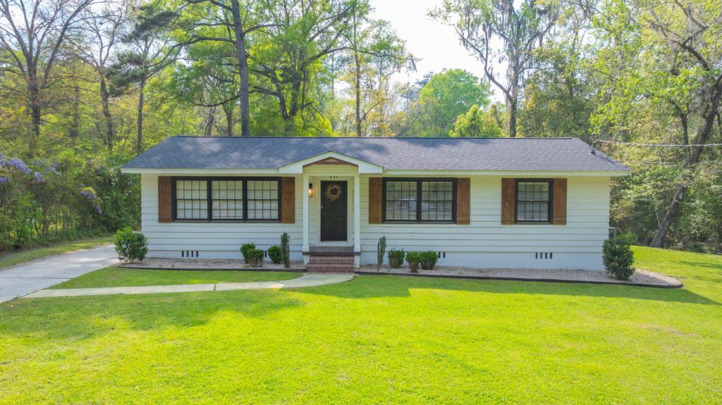 Location, Affordability, and Privacy! This incredible and spacious 3-bedroom, 2-bath home in the beautiful Colonial Heights subdivision offers space, seclusion, and versatility. Enjoy convenient access to Downtown Thomasville, Publix, Lowe's, Archbold Hospital, shopping, and restaurants. The open floor plan, built-in bookcases, and recessed lighting make the home feel modern, fashionable, and bright and airy while still retaining its southern charm. Relax in the spacious primary suite that features a large primary ensuite with double vanities and a luxury tile shower. This property is perfect for entertaining guests—relax with guests on the screened in porch or warm up by the fire with loved ones on chilly nights. There's a creek coursing through the property providing soothing sounds and a nice place to cool off on hot summer days. The two story wired outbuilding is incredible for anyone looking for a workshop, office space, or extra storage space.