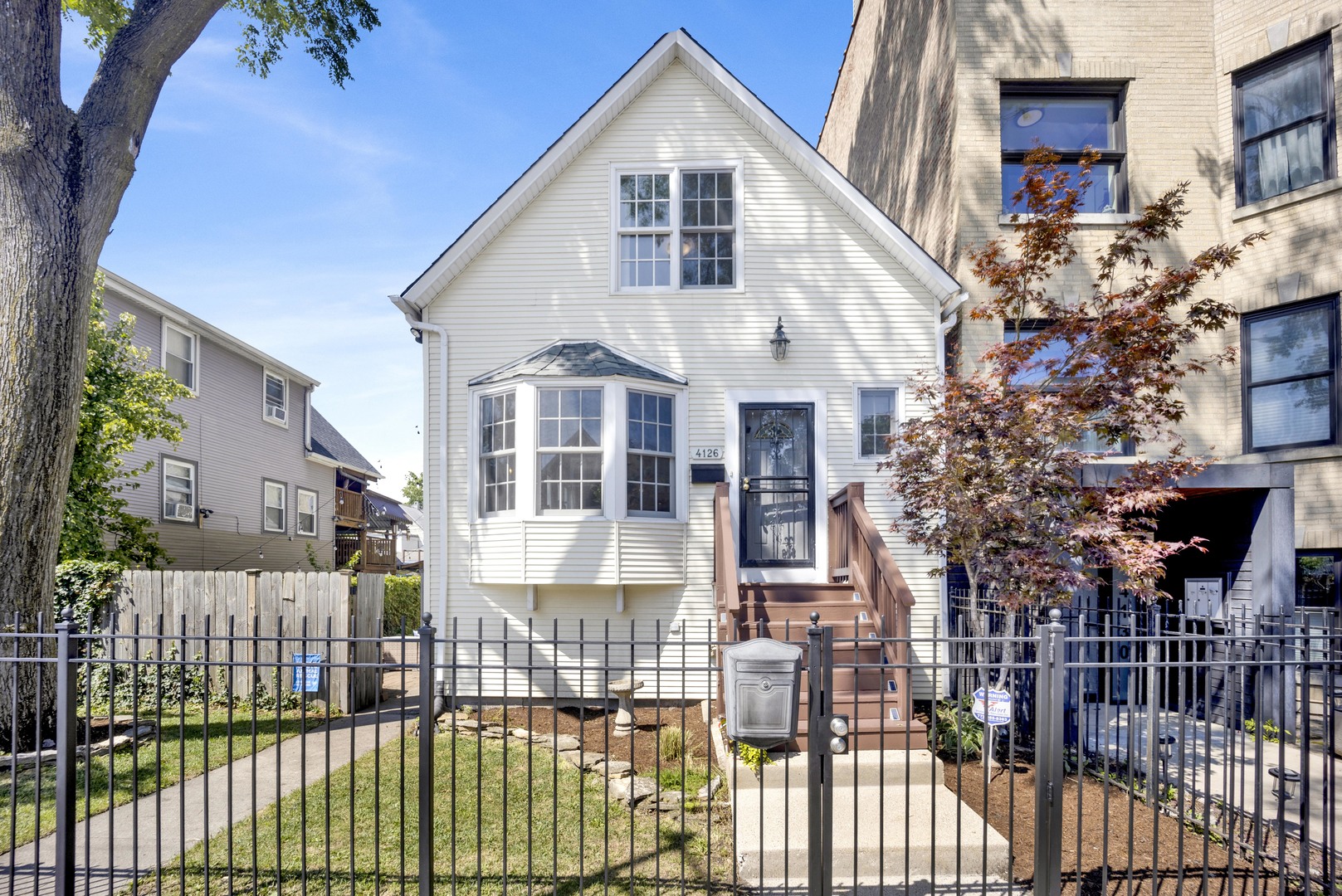 Light, bright & airy 4 bedroom, 2 bath home on extra-wide lot in Irving Park. Set on a 37.5' wide lot, this home enjoys tons of light and a wonderful feeling of space as you move through the intelligent layout. The main floor features spacious living room with bay window, which connects to your dining room, with views of the landscaped side patio. Step into your massive, updated white kitchen with granite counters, GE Monogram stainless steel appliances (including 6 burner range), massive island, walk-in pantry & an attached family room/breakfast area. Flow outside to a true urban retreat: spacious back deck, which steps down to your massive yard, including bonus patio that is a great spot for outdoor dining or outdoor movies. If you like to entertain, this house is made for you! Upstairs, you'll find 3 bedrooms, including a primary that fits a king-sized bedroom. The finished basement offers an additional family room with office/den area that is perfect for guests (we currently have a queen sized bed there), full bath, laundry plus a spacious 4th bedroom with cool reading nook - which could easily double as a private home office, guest quarters, home gym or more! 2 car garage plus parking pad for 2 additional cars, fully fenced yard. Convenient location near CTA Bus and Irving Park blue line, near restaurants and the best part....across from Miko's Italian Ice! Taxes do not include homeowners exemption. Come home! **Multiple Offers Received - Buyers are invited to submit their best offers by 5pm Monday, August 25th.**