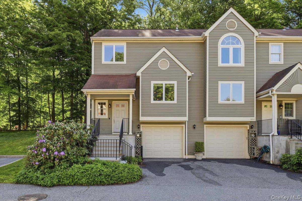 Beautifully renovated end-unit townhouse in highly desirable Guard Hill Manor. The first level of this sun-filled home features an open-concept layout with a gourmet kitchen, spacious dining area, elegant powder room, and oversized living room with fireplace and sliding doors leading to a private terrace — perfect for relaxing or entertaining. The second level offers a luxurious primary suite with ensuite bath and walk-in closet, a generously sized second bedroom with its own bath, and convenient second-floor laundry. The versatile lower level provides ideal space for a home office, gym, or playroom, with direct access to the garage. Enjoy Guard Hill Manor amenities including an inground pool, tennis and basketball courts, playground, and guest parking right outside your door. Ideally located just minutes to shopping, dining, and the Mount Kisco train for an easy Manhattan commute.