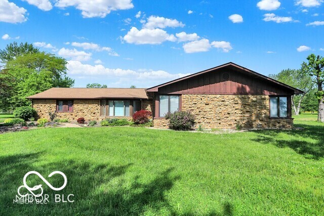 Nestled in the tranquil surroundings of Whiteland, IN lies this exquisite custom-built home, built by renowned local builder Bill Bullock. This property offers an idyllic country lifestyle on a sprawling 3-acre lot. With 5 bedrooms and 3 bathrooms, this property caters to both comfort and elegance. The heart of this home is a generously sized kitchen equipped with updated appliances, skylights for abundant natural light, granite countertops, and custom cherry wood cabinets featuring unique pull-out shelves-a perfect setting for culinary adventures, including a convenient hot water pot filler. The open layout seamlessly connects the kitchen to the living room and dining room, both adorned with updated bay windows that provide serene views of the lush front and expansive backyard, which opens to picturesque farmland vistas to the west. The sunsets are a sight to behold from the back patio! The dining area includes a storage bench under the bay window, and leads to a deck that boasts a built-in stainless steel charcoal grill and a hexagon table for ten, perfect for entertaining. The master suite is a true retreat, featuring a spacious layout, an en-suite bathroom with a double vanity, standing shower, whirlpool tub, and ample walk-in closets. Storage is plentiful throughout the home, which also includes a two-car attached garage and a large 30x40 detached garage, offering versatile space for vehicles or a workshop. The property's vast acreage invites endless possibilities for outdoor activities and gardening, adding to the appeal of a home that combines the charm of rural living with the convenience of no HOA restrictions. This meticulously maintained home with a roof less than two years old is a sanctuary of peace and privacy, promising a quality of life that's hard to find