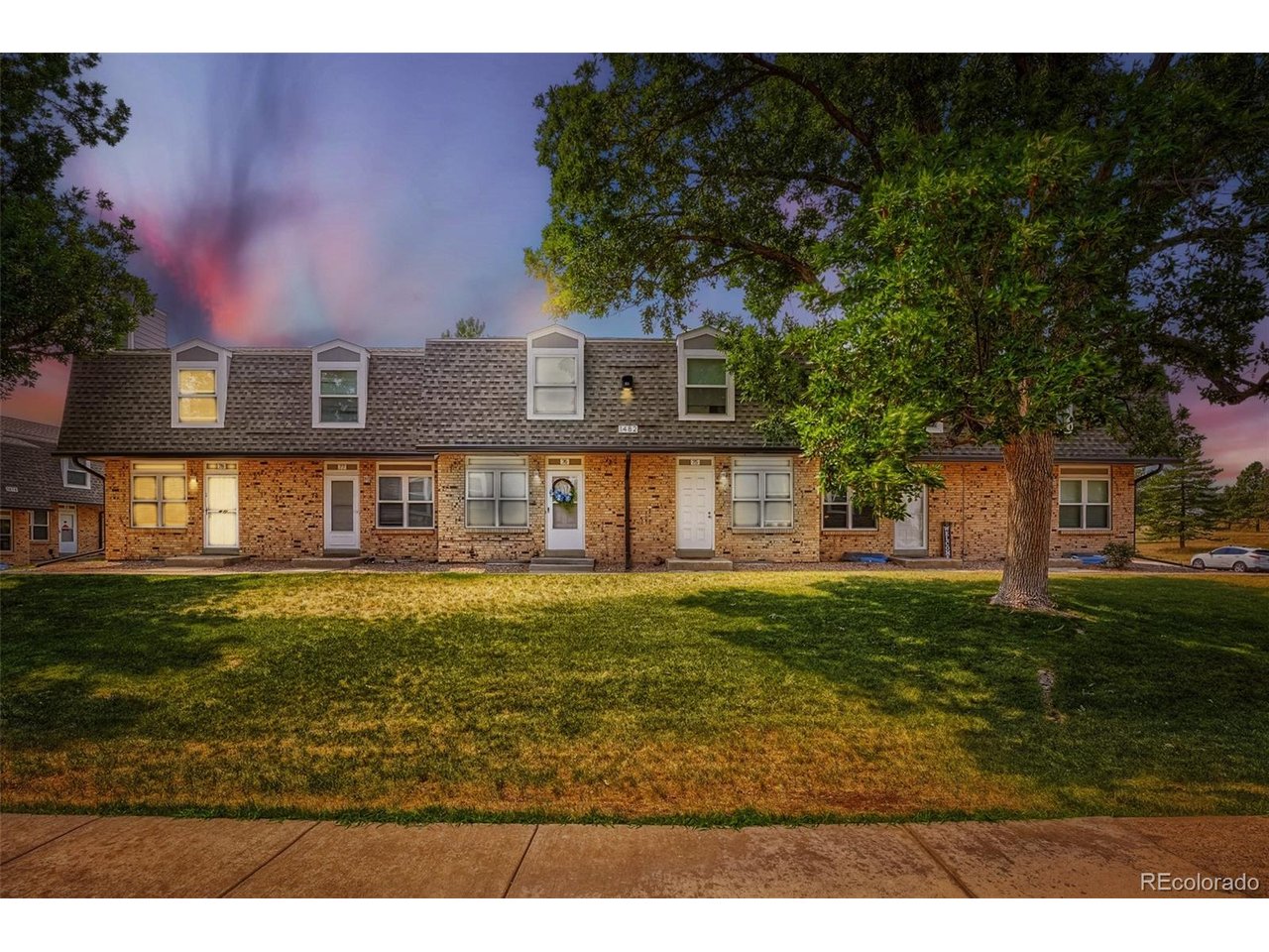 Beautifully updated end-unit townhome offering abundant natural light and a move-in ready interior! Ideally situated with a Denver address on the Lakewood border, this home provides convenient access to the best of both communities.The welcoming main level features an open-concept living and dining area anchored by a cozy fireplace, plus a convenient powder room for guests. The updated eat-in kitchen boasts new flooring, stainless steel appliances, and a brand-new range/oven, making it both stylish and functional.Upstairs, you'll find three spacious bedrooms, a full bathroom, a large linen closet, and brand-new carpet throughout. Every update has been thoughtfully completed to create a fresh, comfortable living space.Enjoy the convenience of a covered carport located directly behind the unit (Space #78), with room to accommodate up to two vehicles. Additional peace of mind comes from a new roof installed in 2025, while the HOA is currently enhancing the community with brand-new fencing.Perfectly located within walking distance to the lake, King Soopers, restaurants, shopping, and everyday conveniences, this home combines comfort, value, and an unbeatable location. Don't miss this exceptional opportunity to own a beautifully updated home in a highly desirable area!
