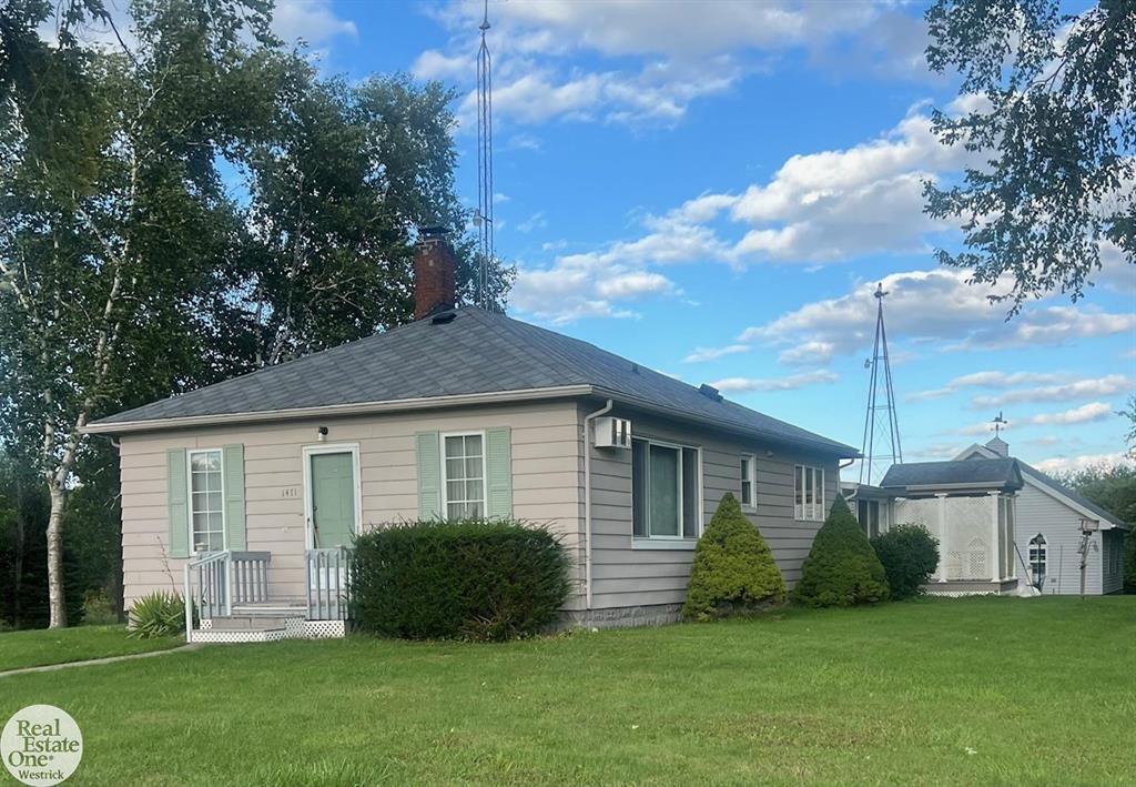 Deer Watchers Paradise! St. Clair Township Michigan - Discover your new beginnings in the One floor home with basement. This 3 bedroom, 2 bath home has a captivating interior that is comfy, cozy and bright. Warm, natural light accentuates the home's interior. Think snuggling up with a good book by the electric fireplace that graces the family room. Note: the fireplace area  was wood then gas now electric and could probably any of those again. From this area go around the corner and down the hall and you will find 2 bedrooms and the bath room with the shower as well hall storage area. Lots of living and crafting space from the basement up through the first floor. The easy to navigate kitchen includes appliances, has a vent pipe already installed for a wood burner and has a pantry. From the kitchen we approach the welcoming dining room with open entry. down the hall from here we find another bedroom with a bathroom across the hall. From this area we walk into the hall to the living room with a room off of it which is currently an office. The full bath is retro original with shower. The basement is a great place for that crafty workspace and workshop heaven. There are glass block windows in basement with vents that open.  You will also find most of the mechanicals in the basement as well as the water treatment system from Water Systems Solutions. (This system uses no salt and offers clean fresh water. and has a filtration system.) Of course basement features extra storage space as well. Newer H2O furnace (2020). Electrical all redone 5 years ago when a Generac Generator was installed. Dukes Broad Band fiberoptics is used for internet. Looking out to the rear 3 season room  with all windows, then out to a large composite deck you will be enthralled with the back yard. Many trails to walk (I have walked them), some barns, a small silo, a 3 car newer garage, a shooting range, and lots of places for the deer to hide. I could go on and on - why not take a peek and decide for yourself?