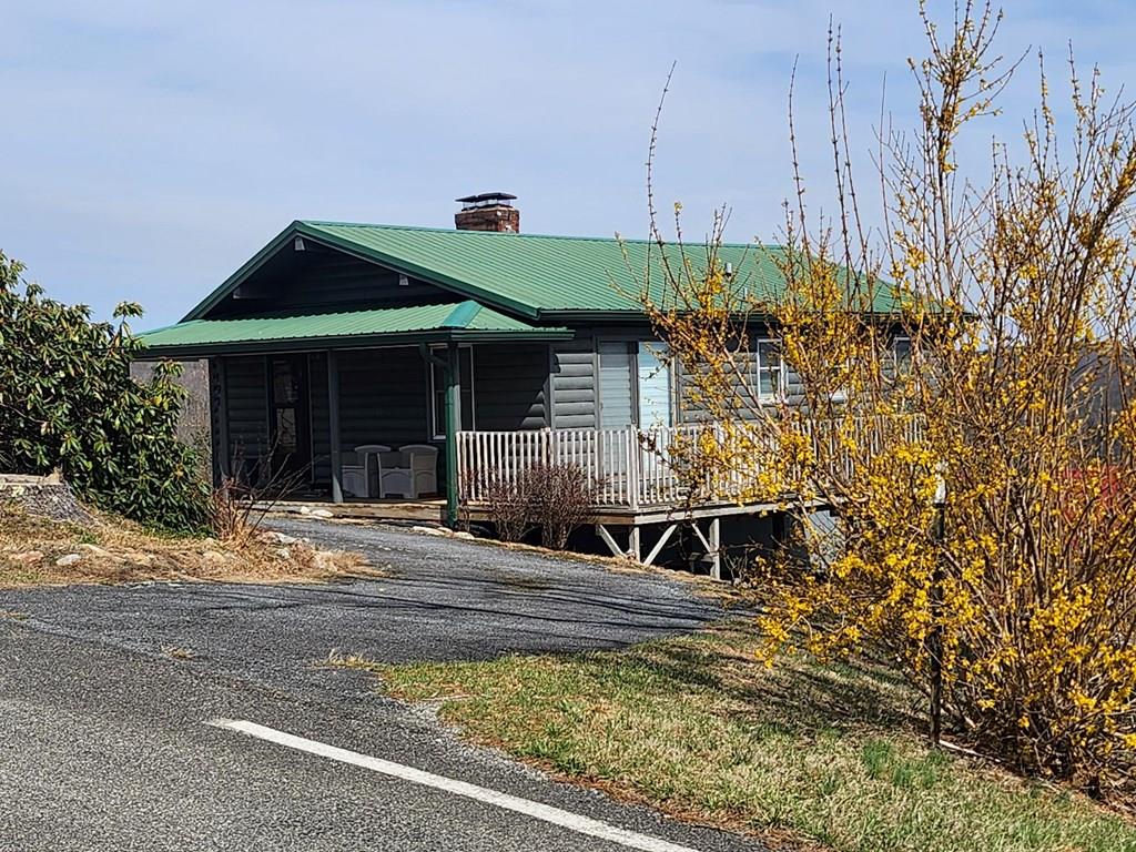 Incredible PIEDMONT VIEWS  are seldom available in this price range. Plus the interior is still like new after being remodeled in 2019. There is easy access to the home from the circle drive (no stairs to climb) as well as easy access to the Blue Ridge Parkway.  Enjoy the open living area and vaulted ceiling in the living room. The kitchen and bath were totally redone with new cabinets, counter tops, flooring, lighting and new stainless appliances including refrigerator, range, dishwasher and microwave. The heat  pump and hot water heater were also installed during the remodel. Other improvements include Pella windows, a propane backup heater. newer gutters and downspouts plus a new storm door. Bring your tooth brush and move  in as the furniture and custom window treatments are included. Chalet High is a golf cart friendly hidden gem of a community directly off the Blue Ridge Parkway with many amenities including Clubhouse, pool, tennis & pickleball courts, gazebo,, fishing ponds and more. The association fee includes community water, use of facilities, road maintenance and, trash dumpsters. Come check it out, you'll be glad you did.