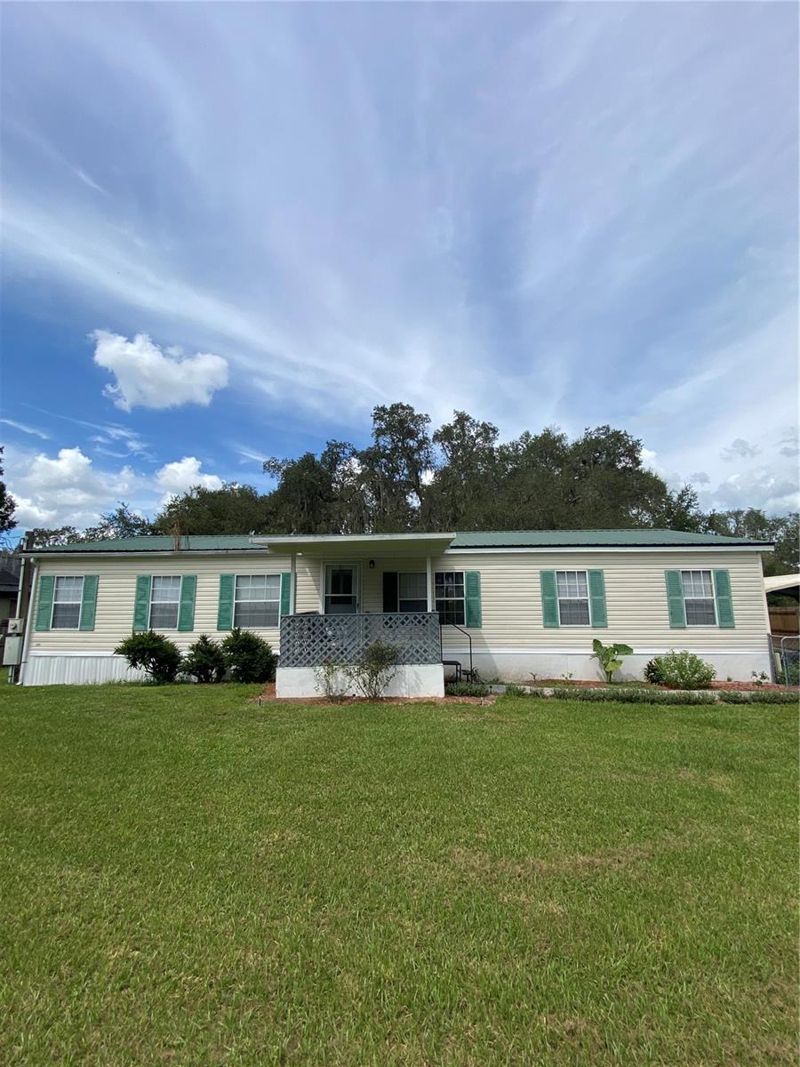 Welcome home to comfort, space, and serenity. This beautifully maintained manufactured home features 3 bedrooms, 2 baths, and a generously oversized room. Nestled on an expansive lot with lush landscaping front and back, the property offers a peaceful retreat with room to relax and entertain. Step out onto the backyard deck and enjoy quiet evenings or joyful gatherings with loved ones. With no HOA or CDD. Whether you're starting fresh or settling in, this home provides the space and support to make it yours.