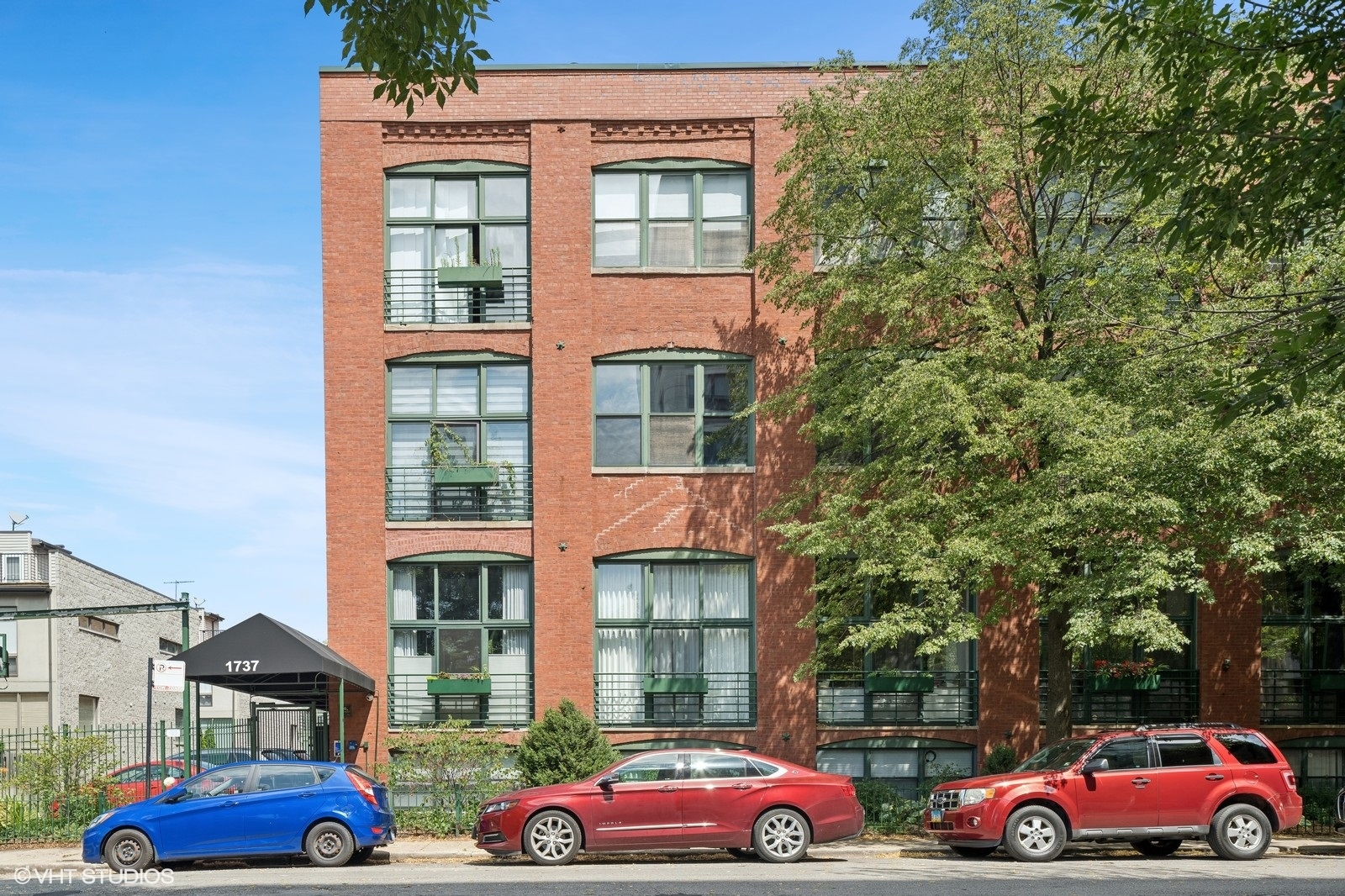 Rarely available top-floor timber loft condo in the heart of Bucktown's sought-after Paulina Lofts. Just steps from the 606 Trail, this classic Chicago loft offers soaring 15-foot ceilings, exposed brick throughout, and an abundance of character. The spacious 2-bedroom, 2-bathroom layout includes a dramatic open-concept living and dining area, a double-sided wood-burning fireplace with a gas starter-shared by both the living room and the primary suite for a cozy, elevated feel. The updated kitchen includes custom cabinetry, quartz countertops, stainless steel appliances, and a classic subway tile backsplash. One of only five units in the building with a second-floor den and wet bar that opens to a private rooftop deck. Stunning western views perfect for sunset entertaining. Second bedroom with huge windows for natural light and full walls enclose the space. Both bathrooms have been thoughtfully updated since the building's conversion. Exterior parking included. Situated in an outstanding location near the 606/Walsh Park, this condo provides easy access to the Metra and Damen Blue Line, and quick access to 90/94 via Armitage. You'll love being close to everything Bucktown and Wicker Park have to offer, including trendy shops, vibrant nightlife, and diverse dining options. Don't miss this opportunity to own a beautiful, spacious, and updated condo in one of Chicago's most sought-after neighborhoods.