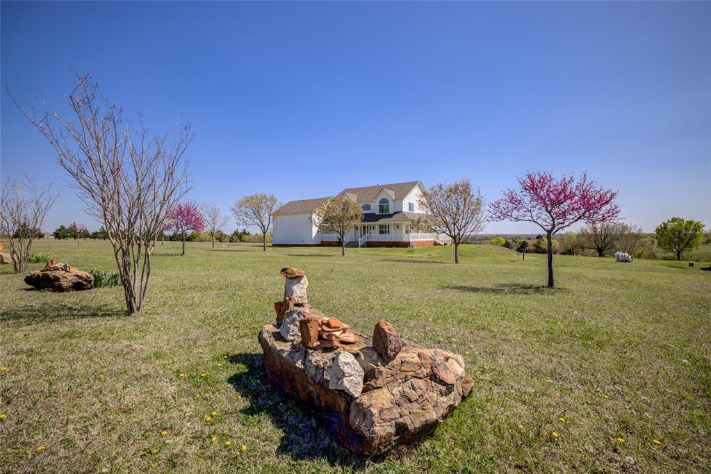 Country living close to the city! This showstopper features custom finishes, large rooms, tons of storage, beautiful views and a workshop on 5 gorgeous acres! Like energy efficiency? This one offers spray foam insulation, a brand new class 4 roof, low-e windows and a 220' deep water well. Other features include granite countertops, a new gas cooktop, water softener, beautiful wood floors throughout, amazing porches and a huge upstairs bonus room that could be an additional bedroom or living room. Want your own peaceful oasis? Stroll down the hill to the seasonal creek and take in the fairytale like atmosphere that can be all your own. Like to work on projects? The home also features a 40x48 shop, 2 overhead doors with openers and a heated and cooled hobby room. There is also an 18x35 RV cover with electric and water/sewer hookups. Also, it is VA assumable with a 5.99% interest rate.  There's so much more so feel free to call with any additional questions about this amazing property!