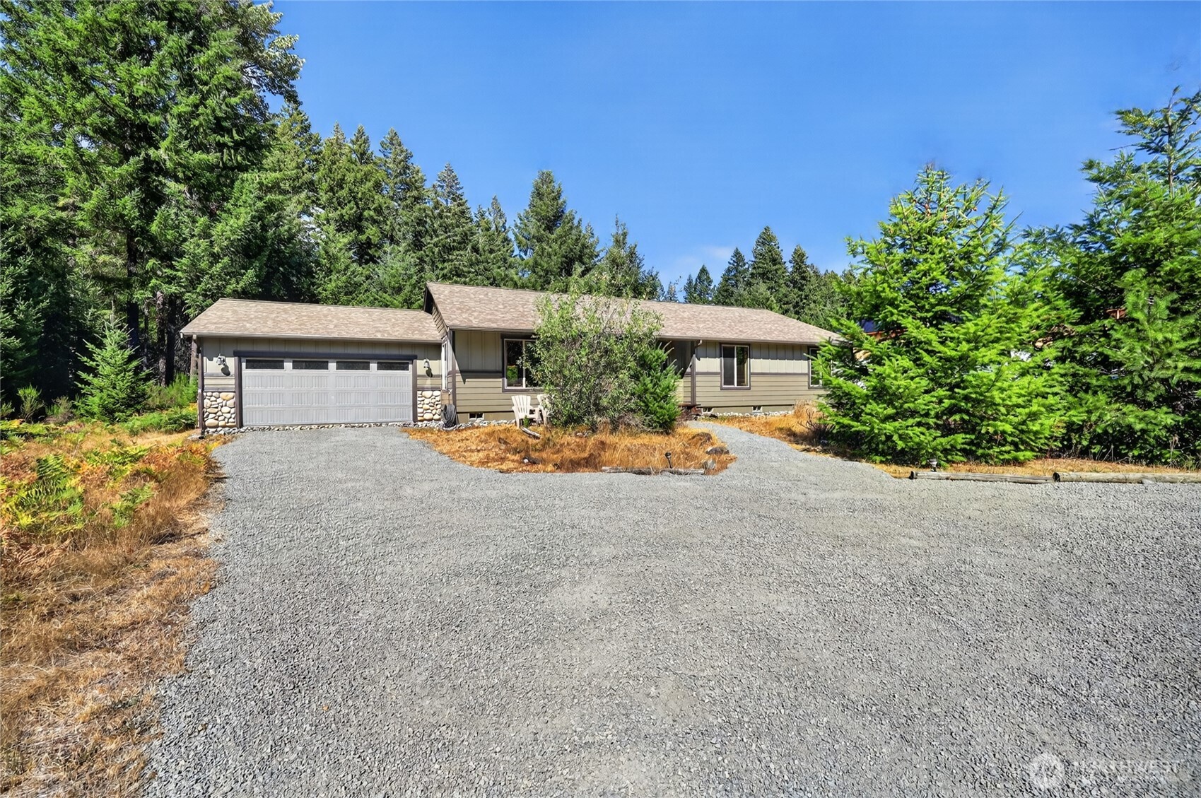 Enjoy the Packwood lifestyle in this newer 1,700+sqft home tucked into the Trails End community. Sitting on over half an acre of flat, usable ground (with a mix of open space and mature trees), there is room here to enjoy the outdoors without giving up the comforts of home! The Cowlitz River is just a short walk away, adding even more opportunity to get out and enjoy your location. Inside, the spacious three bedroom, two bath home offers an inviting layout with plenty of room to gather. The kitchen, dining area, and living room flow together comfortably, creating a space that works just as well for quiet evenings as it does for entertaining. Bedrooms are just down the hall for privacy and to separate the night owls from the early risers. Step outside to the back deck and hot tub, where you can relax and take in the peaceful surroundings after a day in the mountains or skiing on the Pass. An attached garage adds convenience and storage, while the combination of newer construction, usable acreage, river access, and Packwood's outdoor lifestyle makes this property worth seeing.