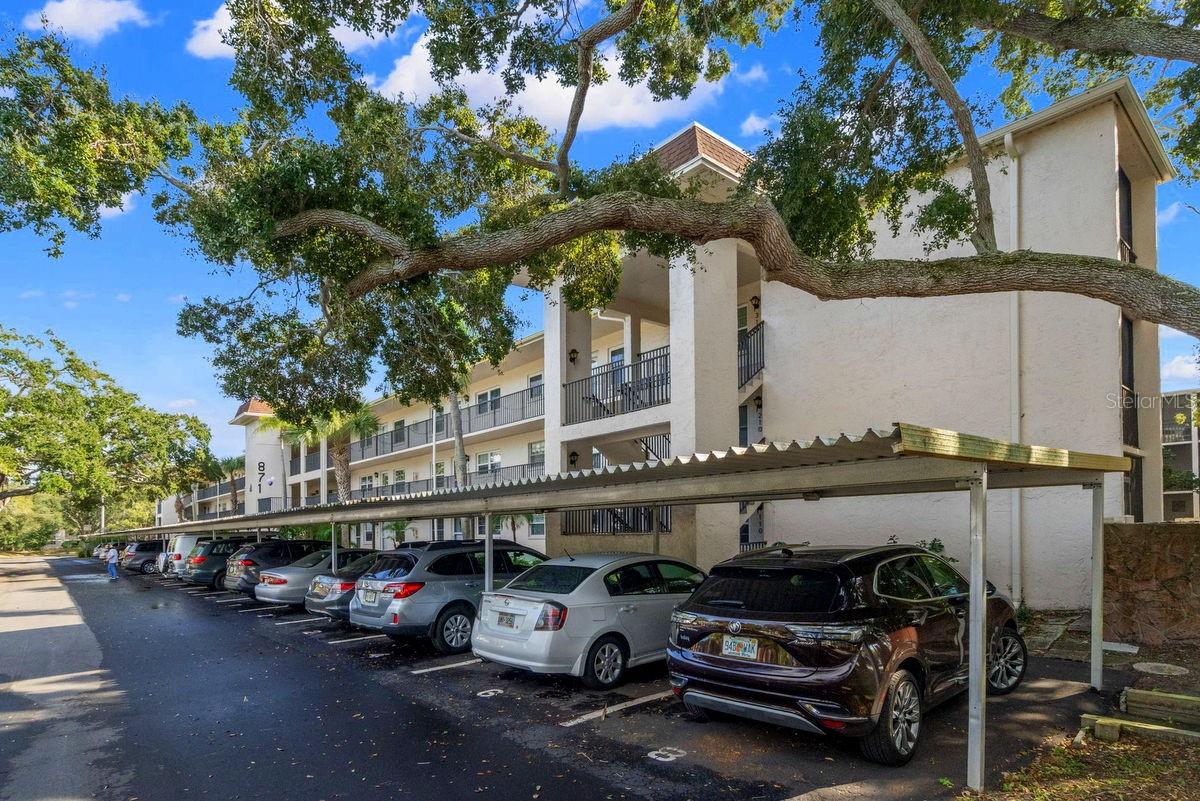 This 3rd floor 2BR/2BA unit offers several updates and is located in the sought after downtown Dunedin community of Patrician Oaks. Community sits on a beautifully landscaped Non-Flood lot with mature tropical plants & majestic trees. The spacious split bedroom plan includes: welcoming foyer, bright kitchen with pass thru, large living-dining room combo, master suite with double closets & private full bath, den or guest bedroom with walk-in utility closet, a full hall bath, PLUS it comes fully furnished with linens, towels, plates, glasses, utensils, cleaning items & more, just bring your toothbrush! The open plan makes this condo great for entertaining and the screened balcony is PERFECT for your morning coffee & evening glass of wine. It features the following updates, KITCHEN: re-painted cabinets, hardware, disposal, and faucet, MASTER BATHROOM: toilet, shower bench, and glass enclosed walk-in shower, DEN: Murphy bed with built-in shelving, HALL BATH: toilet, faucet, and showerhead, INTERIOR: hurricane impact double paned windows, curtains, hurricane impact sliders & shutters, efficient wood laminate flooring, 6-panel doors with hardware, dining chandelier, ceiling fans, front storm door, and bi-fold privacy doors for 2nd bedroom & bath. This Building also has newer walkways, a paved parking lot, plus a newer roof (2023). Building #7 is the community's best kept secret. It offers Free use of the laundry room, the most guest parking spots, and the cheapest fixed land lease fee of $25/month. Patrician Oaks is a meticulously maintained 55+ community with active clubhouse, fitness room, large heated pool & spa, shuffleboard, BBQ grills, and an in-house property manager. It is located a short walk from Historic Downtown Dunedin with its unique shops, top rated restaurants & countless activities. It's also a short drive from several shopping hubs, the Dunedin Causeway, Honeymoon Island, Westfield Mall, Quaint Ozona, Eclectic Safety Harbor, Award Winning Clearwater Beach, and the famous Sponge Docks of Tarpon Springs. Ride your bike on the Pinellas Trail, take a stroll on the Causeway or watch a waterfront sunset over the Marina, there's plenty to do in Dunedin! Other amenities include: beaches, parks, casual & fine dining, roof top bars, micro-breweries, cafes, bike riding, boating, fishing, downtown festivals, concerts, art shows, spring training baseball, championship golf, sunsets, and events at the Community & Fine Art Centers. This is a MUST SEE for buyers seeking maintenance free living with an active & vibrant lifestyle this property conveys.