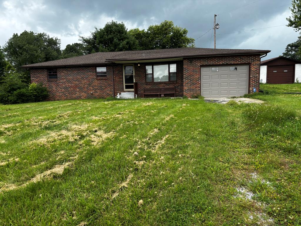 3 Bedroom, 1 bath brick home on nice 1 acre lot out of town. Additional room that could be used as a bedroom, office or family room. New flooring. Unfinished basement. Detached 1 car garage.Newly remodeled bathroom