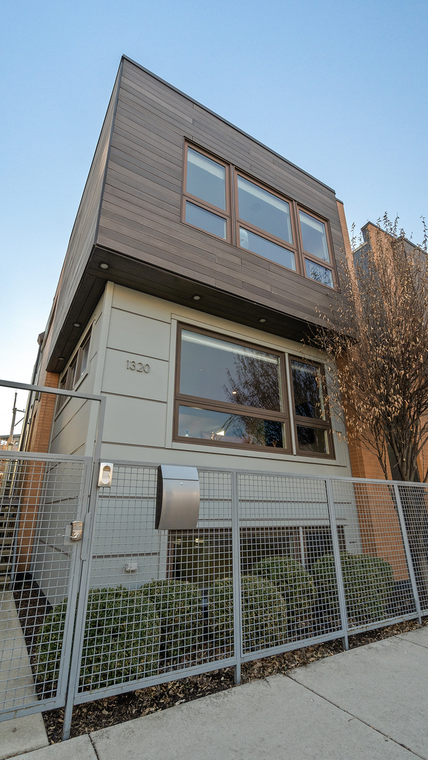 Nestled in one of Wicker Park's most coveted locations, just two blocks from Division Street, this stunning 4-bedroom, 3.1 - bath SmartTech single-family home is designed for luxurious living and seamless entertaining. Step inside to a welcoming entryway with custom-built cabinetry, leading to a sunlit living room with a large picture windows. The chef's kitchen features a spacious island, designer backsplash, and a dining area illuminated by a Sonneman Constellation light fixture and indirect tray ceiling lighting-perfect for intimate dinners or lively gatherings. A stylish main-floor powder room adds convenience. Upstairs, the serene primary suite offers custom Hunter Douglas electric blinds, multiple closets including a walk-in, and a spa-like en-suite bathroom with a heated floor, dual vanity, oversized shower with a bench, rain shower head, massage body spray, and volume control. Two additional bedrooms provide generous space, and the second full bath boasts a heated floor, skylight, and tub/shower combination. The fully finished lower level is ideal for a media room, play area, or home gym, featuring new carpeting, fresh paint, a European-style water closet, and a fourth bedroom with ample closet space. The exterior, fully repainted in 2020, is complemented by custom landscaping, deck planters, and a timer-controlled irrigation system by Reveal Designs. A fully finished deck with wired speakers, a pergola, a custom fire feature/table, and a Weber grill-each with dedicated gas lines-creates an entertainer's dream, while the landscaped backyard offers a peaceful retreat with irrigated raised beds for flowers or a vegetable garden. Additional highlights include a whole-home sound system with ceiling speakers inside and on the deck, wall-mounted TV wiring in key rooms, custom Closet Works storage solutions, and eco-friendly features such as SmartTech1.5, an Energy Star rating, and no VOC paint. Recent upgrades include roof repairs in 2022. Located steps from the Division Blue Line and Wicker Park's best dining, shopping, and nightlife, this meticulously maintained and thoughtfully upgraded home is a rare gem in one of Chicago's most vibrant neighborhoods.