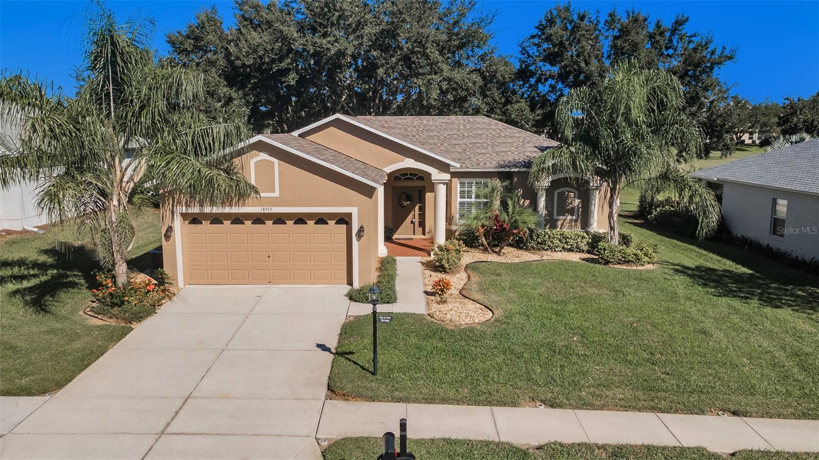 From the elegant front portico and pristine landscaping to the spacious screened lanai with views of the verdant golf course’s 14th fairway, this house makes an absolutely lovely home. Three bedrooms and two full bathrooms offer ample flexibility to invite houseguests and/or to fashion a private study or yoga studio. A NEW roof was added in 2024 and NEW sliding doors installed in 2023. This Victoria III floor plan is filled with fresh Florida sun and includes nuances like bay windows and an entryway transom. Curved arches embellish doorways and sleek flooring make this inviting space shine. From the foyer the site line takes you through the formal living and dining rooms to the sliders revealing the almost 300 SF lanai, backyard, and golf course. The eat-in kitchen with windowed breakfast nook, granite countertops, tons of cabinetry, and slate GE appliances are all lit by recessed lighting. Another set of sliders leads to the outdoor space, making the perfect venue for relaxing and entertaining. A huge passthrough from the kitchen introduces the family room. Accented with another bay window and a casual dining bar, this room has Sunday Football and Movie Night written all over it! Over a split bedroom floor plan, the large master suite is well appointed with decorative niches adding architectural interest; a third set of sliders to the lanai brings the outside, in. Dual walk-in closets, dual sinks, and a tiled shower room complete the retreat. The other two bedrooms and full bath are immaculate. A sizable laundry room is a welcome alternative to these oft-garaged appliances. Heritage Pines is a premier 55+ community. Beyond the gates (where your guests will be welcomed at the guard house), you’ll enjoy a plethora of activities and amenities to share with family and friends. Besides the spectacular pool and jacuzzi, there are courts to accommodate bocce ball, pickleball, and tennis. The richly designed clubhouse welcomes you to a full-service restaurant accompanied by a fitness center, woodworking shop, crafts room, card room, and billiards table. In addition to low HOA fees (which cover cable and lawn maintenance), you’ll travel less than 20 minutes to Hernando Beach and the incomparable Weeki Wachee Springs State Park and less than 60 minutes to points south like Clearwater and Tampa International Airport. While you’ll appreciate the proximity to these destinations you’ll relish this quiet enclave in sought-after Hudson.