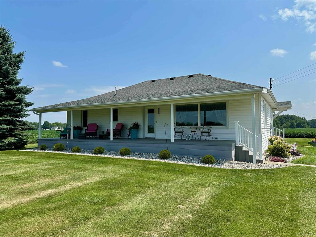 Welcome to your dream country retreat! This beautifully maintained 3-bedroom, 2.5-bathroom ranch home offers over 1,750 square feet of comfortable living space, all nestled on 77.2 sprawling acres of prime farmland, approximately 10 acres of which is wooded. Perfect for finding that trophy buck!  From the moment you arrive, you'll be captivated by the charm of the 47-foot covered country porch-the perfect spot for morning coffee or evening sunsets. Step inside to find thoughtful updates throughout, including a recently added first-floor laundry and half bath, a new roof in 2019 and an incredible rear family room addition with breathtaking panoramic views and gorgeous natural light which will beam off of the hardwood floors. This spacious room is the heart of the home, perfect for hosting those family gatherings and providing comfort year-round with a high-efficiency mini split for supplemental heating and cooling.  The master bedroom is your private escape, complete with a walkout to a covered patio where you can relax and soak in the peaceful beauty of your farmland backdrop.  Downstairs, the partially finished basement features a kitchenette, cozy living area, full bathroom, and additional laundry space-ideal for guests, entertaining, or multi-generational living. A battery backup for the sump pump adds peace of mind.  Outdoors, the property continues to impress with a detached 2-car garage, complete with a 20' x 12' lean-to, perfect for storage or workshop needs. On the northern edge of the parcel, you'll find not one but two large pole barns-a 70' x 40' and a 56' x 32'-offering endless possibilities for storing equipment, your big toys, livestock, or hobby farming.