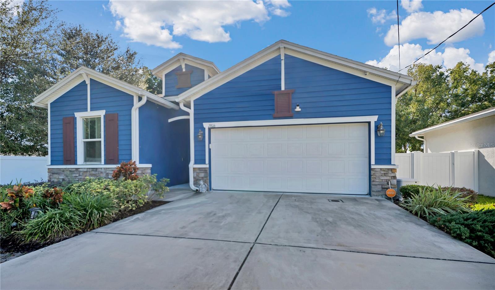 Built in 2018, this thoughtfully designed single-story concrete block residence offers a desirable 3-bedroom, 2-full-bath, 1-half-bath with a split floor plan, providing added privacy by separating the primary ensuite from the two secondary bedrooms. The home features approximately 2,200 square feet of heated living space, with a total building area of approximately 2,836 square feet, inclusive of the garage, enclosed lanai, and covered areas, all situated on an oversized 8,750 sq. ft. lot in West Tampa. The home features a contemporary aesthetic highlighted by high ceilings, ceramic tile flooring throughout the main living areas, and a dedicated formal dining space ideal for entertaining.  Multiple rooms are equipped with wall-mounted televisions already installed, enhancing the home’s move-in-ready appeal. The well-appointed kitchen serves as a functional and inviting culinary hub, featuring granite countertops, 36" cabinetry, upgraded stainless steel appliances, an undermount stainless steel sink, pantry storage, and recessed lighting.  The primary ensuite is offered fully furnished, providing a turnkey retreat with a tray ceiling, a spacious walk-in closet, and a spa-inspired full bath complete with dual comfort-height vanities, granite countertops, a garden tub, a private enclosed toilet room, and a separate tiled shower with glass enclosure. Additionally, a separate utility room accommodates a full-size washer and dryer and includes a standalone washing basin and hanging rack.  Additional interior highlights include designer lighting, solid-surface window sills, stainless steel fixtures, recessed LED lighting, and a dedicated home office with ample space suitable for a full home exercise gym, offering versatile use to meet today’s lifestyle needs.  The property includes a 2-car garage and a long driveway ideal for tandem parking, providing ample off-street parking. Step outside to the enclosed lanai with cemented flooring, offering seamless indoor-outdoor living. The backyard provides space for grilling and recreation, with a non-attached storage shed offering additional storage.  Energy-efficient features include Low-E dual-pane windows, Carrier central HVAC, programmable thermostats, a tankless water heater, and a 22kW Generac whole-house generator with a 200-amp transfer switch (added in 2022). Conveniently located near major roadways, downtown Tampa, shopping, dining, and local amenities.  Showings are by appointment only. No showings after 6:00 PM