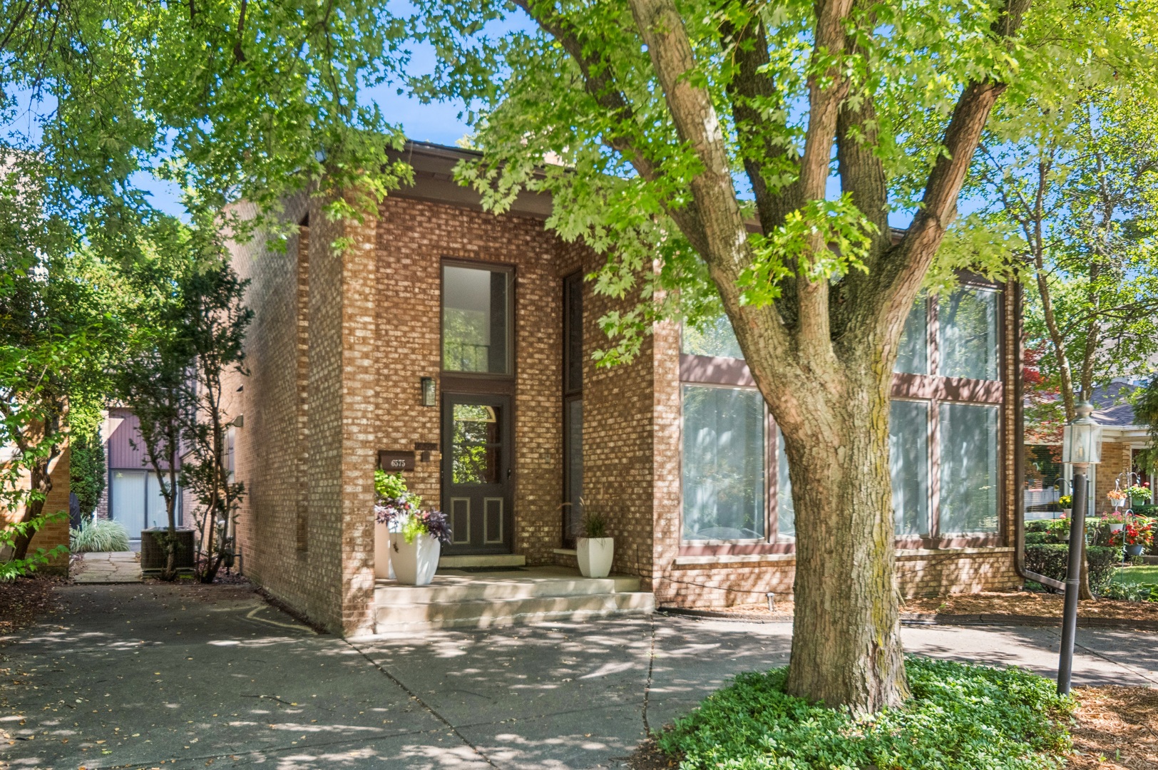 Wow! That is the reaction when entering this uniquely designed, contemporary custom built home in the Wildwood/Edgebrook neighborhood. This is NOT your typical Chicago home. Soaring angled ceilings with sky-lights, oversized windows, lovely light hardwood floors accented with dark inlay details and a surprising outdoor courtyard. The foyer is striking with its dramatic open staircase that leads your eyes upward to a mezzanine balcony. The LR is cathedral-like with symmetrical columns framing a 2-story wall of glass with views of the Caldwell Woods. There is a free standing brick wood burning fireplace that anchors the room and separates the living space from the foyer. The striking balcony breaks this open space with its classic horizontal lines. From the formal DR you can access the impressive kitchen and inviting family room. This Chefs Kitchen has warm cherry cabinets with leaded glass fronts and granite countertops. There is a large island with a convenient prep sink and seating. There is a Gaggenau built-in cook-top and oven, a paneled refrigerator, trash compactor and built-in desk area. A few steps down to the family room with a 2nd wood-burning fireplace and views of the fabulous outdoor courtyard. The courtyard is a delightful tranquil space, located within the walls of this sophisticated home. From the courtyard you have access to an Amazing 20 x 40 open aired rooftop deck. Down the hallway from the family room is access to the garage and into a separate and private living area with sleek white kitchenette, a large bedroom and updated en suite bath. There are 2 separate and private bedrooms on the 2nd level. The primary bedroom is a serene retreat with its elegant dressing room and updated ensuite bath. There is a 2nd bedroom with its own en suite bath. There is a 4th bedroom downstairs with easy access to its own 4th full bath, just up the stairs on the main floor. Recent updates include: All the HW floors have been refinished in a light stain, the entire house has been freshly painted within the past few years, the primary bedroom and in-law en suite baths have both been updated with custom built-in closets, new kitchenette in the in-law suite, new light fixtures, new pavers in courtyard, new A/C unit. Located in the lovely Wildwood/Edgebrook neighborhood, with easy access to Caldwell Woods, the charming town of Edgebrook with the Metra, shops and restaurants, 90/94, downtown and O'Hare. Schedule your showing today!