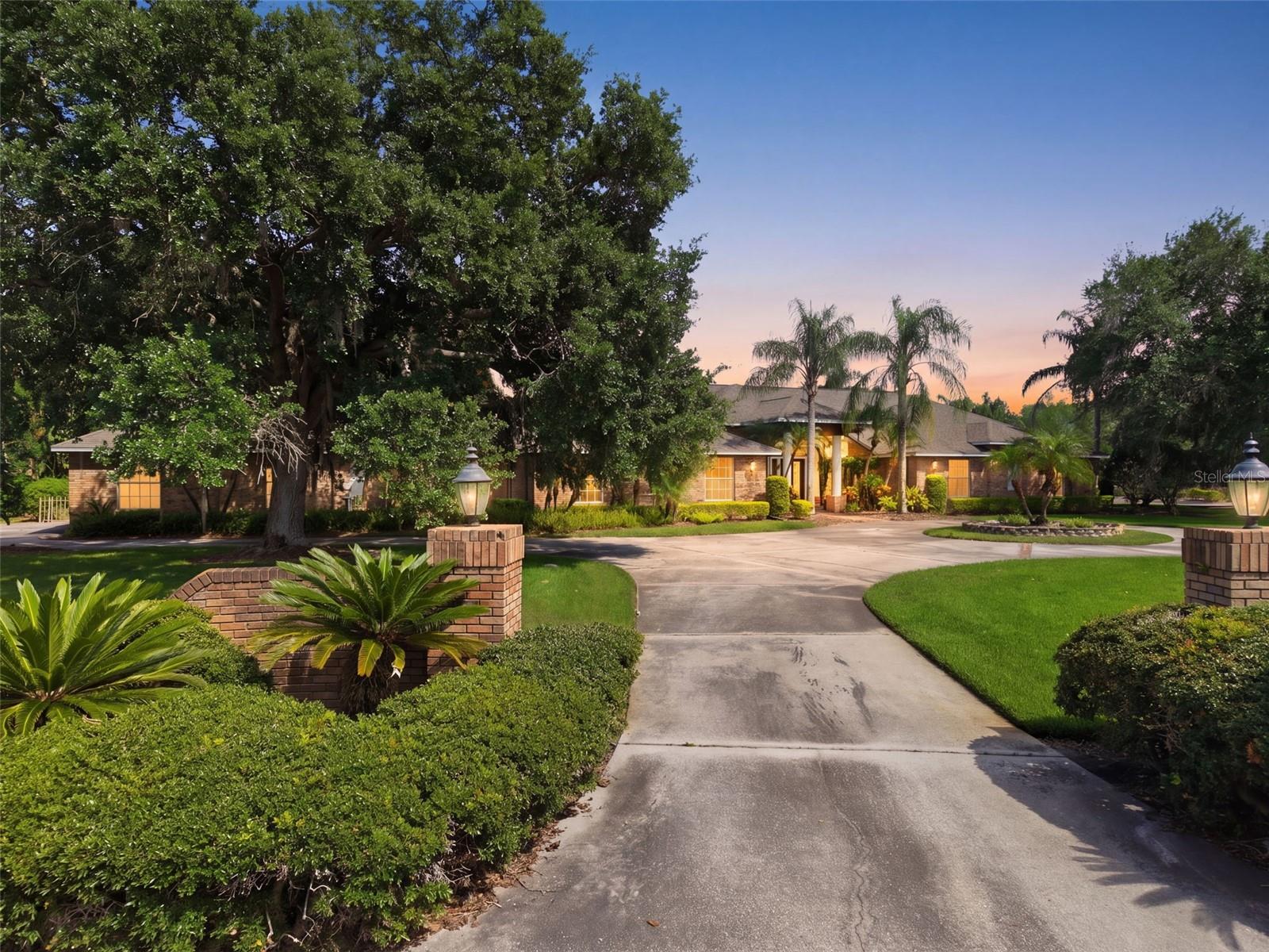 Under contract-accepting backup offers. Virtually Staged. Located on one of the most exclusive streets in Cheval.......Welcome to 18701 Pepper Pike in Cheval Golf and Counrty Club.A rare opportunity to own a 6,200+ sq ft estate on over an acre—perfectly positioned on Hole 1 and enveloped in lush, mature landscaping that creates a private, garden-like sanctuary. Tucked behind a fully fenced setting with beautiful greenery, the property offers a level of privacy rarely found, evoking the feeling of a secluded secret garden retreat within one of Tampa’s most sought after gated communities.From the moment you arrive, the home’s scale and presence are undeniable. Inside, a grand yet inviting layout unfolds with 6 bedrooms, 4.5 bathrooms, and a collection of thoughtfully designed living spaces ideal for both elegant entertaining and everyday comfort. Formal living and dining rooms set a refined tone, while the expansive game room with a striking brick fireplace and a dedicated bonus/theater room provide exceptional flexibility for hosting and relaxation.Designed with both functionality and privacy in mind, the home features distinct living wings. The primary wing serves as a true retreat, offering the luxurious owner’s suite along with three additional bedrooms—two connected by a Jack-and-Jill bathroom and one with its own private en suite—creating an ideal configuration for family living. A separate guest wing includes two additional bedrooms joined by a beautifully appointed Jack-and-Jill bathroom, perfectly suited for guests, extended family, or a quiet home office environment.At the heart of the home, the spacious kitchen flows seamlessly into a large family room anchored by a grand brick wood-burning fireplace, creating a warm and welcoming central gathering space. LVP flooring throughout the bedrooms, living room, and family room adds a clean, modern touch while maintaining durability and style.The primary suite is a true sanctuary, highlighted by a fully renovated, spa-inspired bathroom (2023). All guest bathrooms have also been tastefully updated (2023) with timeless finishes, offering a cohesive sense of understated luxury throughout.Step outside to a private resort-style setting where a lagoon-style pool with a dramatic rock waterfall and hot tub serves as the centerpiece of an expansive lanai with over 3000 sq ft of entertaining space.Outside of the lanai is surrounded by mature landscaping and open green space, the backyard is designed for both peaceful relaxation and effortless entertaining.Recent improvements include a new ROOF (2022), three HVAC systems (2022), and a TANKLESS HOT WATER HEATER (2023), providing modern comfort and peace of mind.As a resident of Cheval Golf & Country Club, enjoy access to exceptional amenities including a clubhouse with dining, tennis courts, fitness center, and swimming facilities, all within a 24-hour manned gated community. The championship golf course is private and available by optional membership.Ideally located within the highly sought-after Steinbrenner school district, Cheval offers a premier lifestyle just minutes from top-rated dining, shopping, and major highways, with convenient access to downtown Tampa and Tampa International Airport—both approximately 20 minutes away.Offering exceptional value for its size, setting, and location, this is a rare opportunity to secure a true estate property in Cheval—where homes of this scale and privacy seldom come to market.