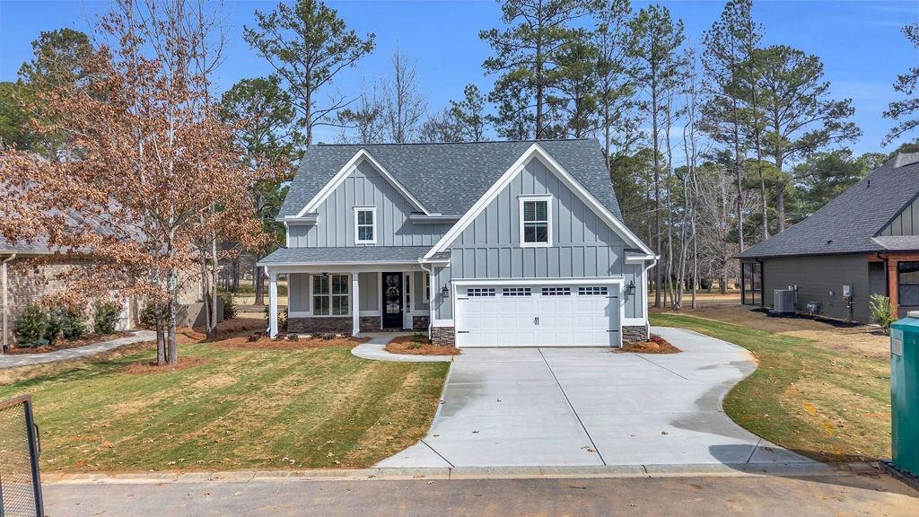 MOVE IN READY JUST COMPLETED and includes both your Grand Harbor Membership and 1 year of family golf dues paid in advance for you!   Start your new life with Lifestyle Home's new McKenna Plan which delivers exceptional farmhouse open cottage design offering everything your lifestyle desires in a spacious first floor--with plenty of room for guests, offices, fitness rooms upstairs. The large foyer reveals the spectacularly vaulted ceiling that creates a light-filled, inviting Great Room with  fireplace, and a wall full of glass doors that open to your covered porch with a spectacular view of the 10th hole at Grand Harbor Golf Course!  Your family will cherish memories of gatherings in the spacious, airy dining room right off the foyer.  Casual, open plan kitchen invites gatherings around a huge quartz island.  You'll love the cabinet space--plus a well planned corner pantry that will hold all that coveted cookware and supplies.  You'll delight in spending time in the charming, sunny dining/breakfast room, experiencing nature and watching the golfers. Relax in the spacious primary suite which has tray ceilings, views of the golf course and a sumptuous bath with soaking tub, large tiled and glass enclosed shower, dual sinks,  and two generous walk in closet spaces. Your casual guests will appreciate the powder room just off the kitchen.  And you'll love the laundry room with it's additional storage opportunities and a wet sink--great for cleaning those golf shoes or bathing that puppy.  The open staircase leads to the guest and flex suites--two bedrooms, two bathrooms and a very generous finished bonus room/bedroom with access to great attic storage. Your family and friends will spend hours enjoying grilling and relaxing on your 28' long covered back porch.  Of course, you'll experience luxurious flooring, granite and/or quartz countertops, modern fixtures, deep crown molding and options for wainscoting, judges paneling and ship lap accents, soft close cabinetry, vented microwave fan, gas heat, instant on hot water heater, insulation above code, beautifully landscaped and irrigated yard outside of your generous 2.5 car garage. Best of all, this home includes membership to the prestigious Grand Harbor Golf & Yacht Club in this spectacular gated community offering a grand lifestyle filled with golf, fitness, pool, marina, pickleball, tennis, playground, boat storage, clubs, events, restaurant and so much more. Grand Harbor is serenely situated on Lake Greenwood, but is close to both the historic town of Ninety Six SC and the bustling town of Greenwood SC with exceptional healthcare facilities and easy shopping. Home is vacant; Some Virtual Staging Photos   SELLER IS SC REAL ESTATE AGENT