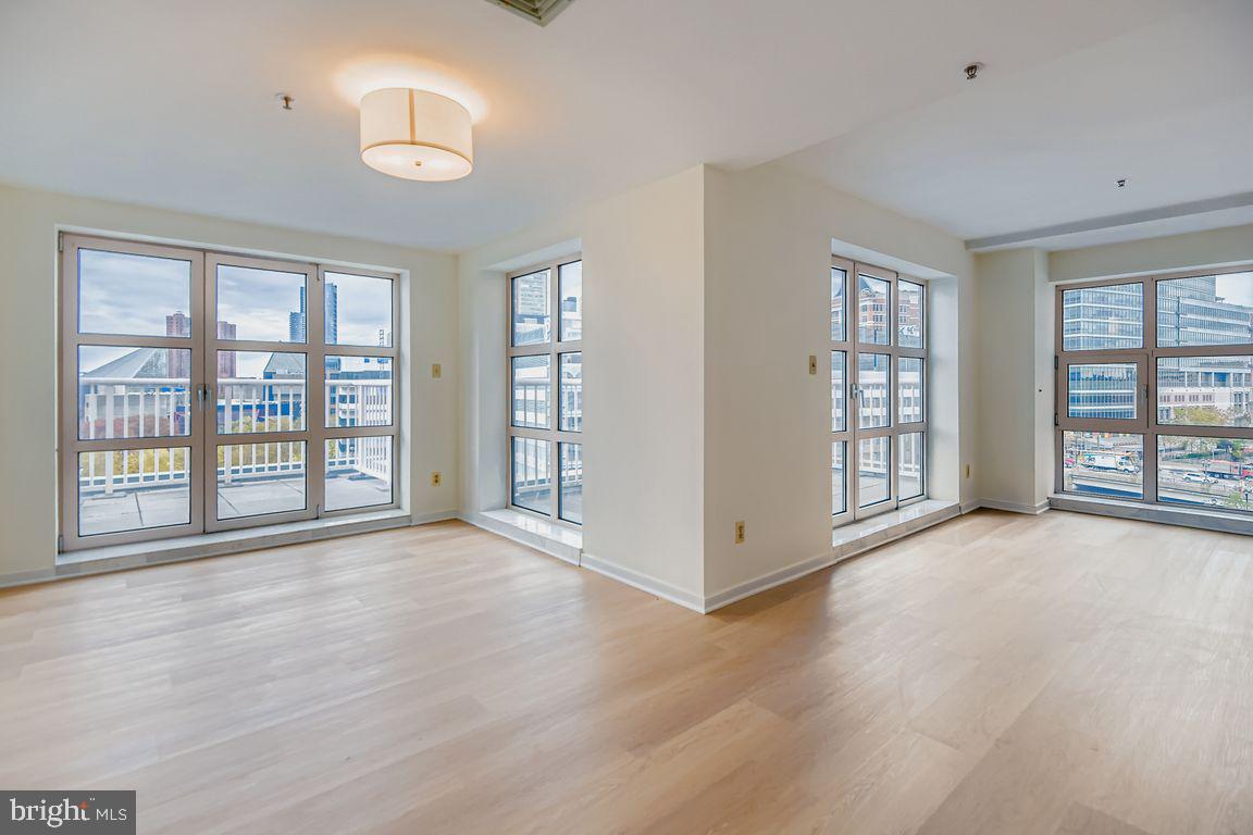 Rarely Available Three-Bedroom with Stunning Inner Harbor ViewsOffered for resale for the first time since the building’s construction, this spacious three-bedroom residence captures gorgeous water views of the Inner Harbor from an expansive wall of oversized windows and two sets of French doors opening to two terraced balconiesThe bright, open layout features new white oak luxury vinyl plank flooring throughout—no carpet anywhere—and an elegant double-door entry leading into a welcoming formal hallway with a coat closet. The primary suite boasts dual walk-in closets and a spa-like ensuite bath with whirlpool tub. Ample natural light pours in from dual corners, creating a warm, airy feel throughout the home.Additional highlights include a separate utility room with laundry hookups and a linen closet in the second bath. Freshly updated and move-in ready, this residence also conveys with one parking space in the attached garage and a separate storage locker conveniently located on the same floor.Enjoy the best in full-service living in this secure, elevator building with a 24-hour front desk, on-site manager, and maintenance staff. Luxury amenities include an indoor pool open year-round, state-of-the-art fitness center, resident library and game room, elegant lounge, and an expansive outdoor sundeck featuring a pergola, gas grills, granite bar, and lush landscaping.Experience refined city living at one of Baltimore’s most prestigious addresses.