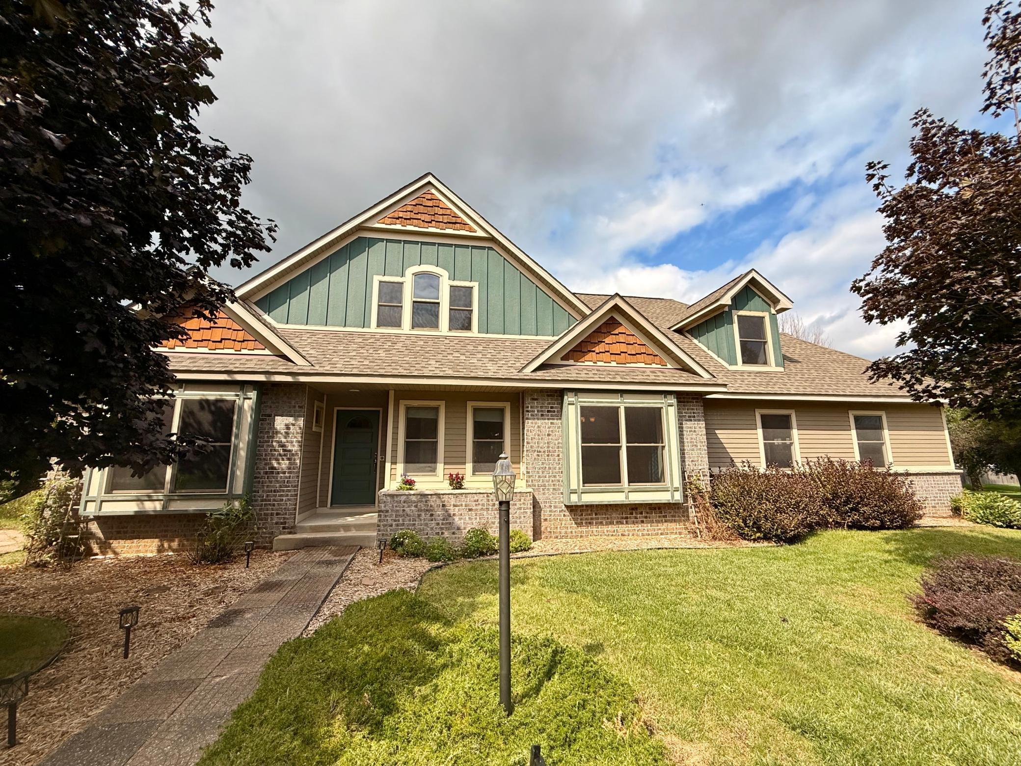 OPEN HOUSE: 9/11/25 5:00-7:00
Welcome to this stunning one and a half story bungalow cottage, perfectly situated on a spacious .3 acre corner lot near the city park. This beautifully designed home features four bedrooms plus a den, and boasts 3 and a half bathrooms, making it ideal for families or those who love to entertain. As you enter, you'll be greeted by the impressive main floor, which showcases 8-foot ceilings in the living areas and 9-foot ceilings in the raised living room, complete with electric cove lighting and surround sound. The heart of the home is the large kitchen, featuring custom maple cabinetry, a center island with a snack bar, and a gas double oven range. Enjoy the convenience of a main floor laundry and mudroom, along with a half bath and sun tunnel for optimal daylight. The outdoor space is equally inviting, with a curved deck in an arbor and a covered outdoor deck equipped with a ceiling fan, perfect for relaxation. Upstairs, discover an activity loft and dual suites, with one bedroom featuring charming dormer nooks and a walk-in closet, while the second suite boasts expansive windows and French doors for abundant natural light. The luxurious walk-through super bath includes a 6-foot whirlpool tub with skylights, dual vanities, and a separate toilet room. The lower level offers an additional bedroom, full bath, and a family room with a wet bar, along with a den and a storm shelter room. The exterior is finished with LP smart side siding and cedar shakes, complemented by a brick planter area and a side paver patio. This home is a must see!